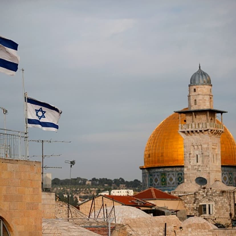 Israeli flags fly near the Dome of the Rock in the Al-Aqsa mosque compound on December 5, 2017. The EU's diplomatic chief Federica Mogherini said that the status of Jerusalem must be resolved "through negotiations", as US President Donald Trump mulls rec