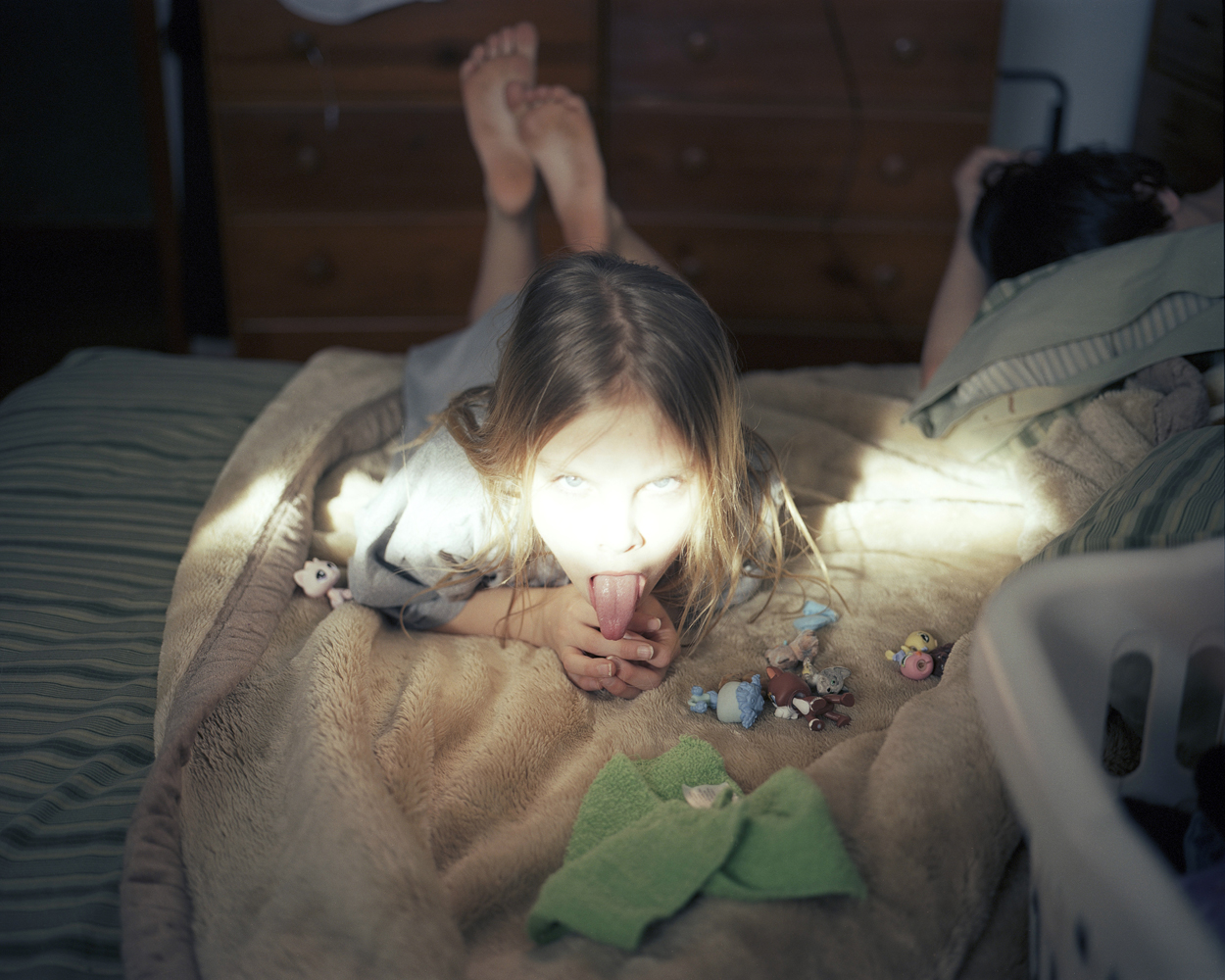 Erica with her toys and a sliver of sunshine.  2008 