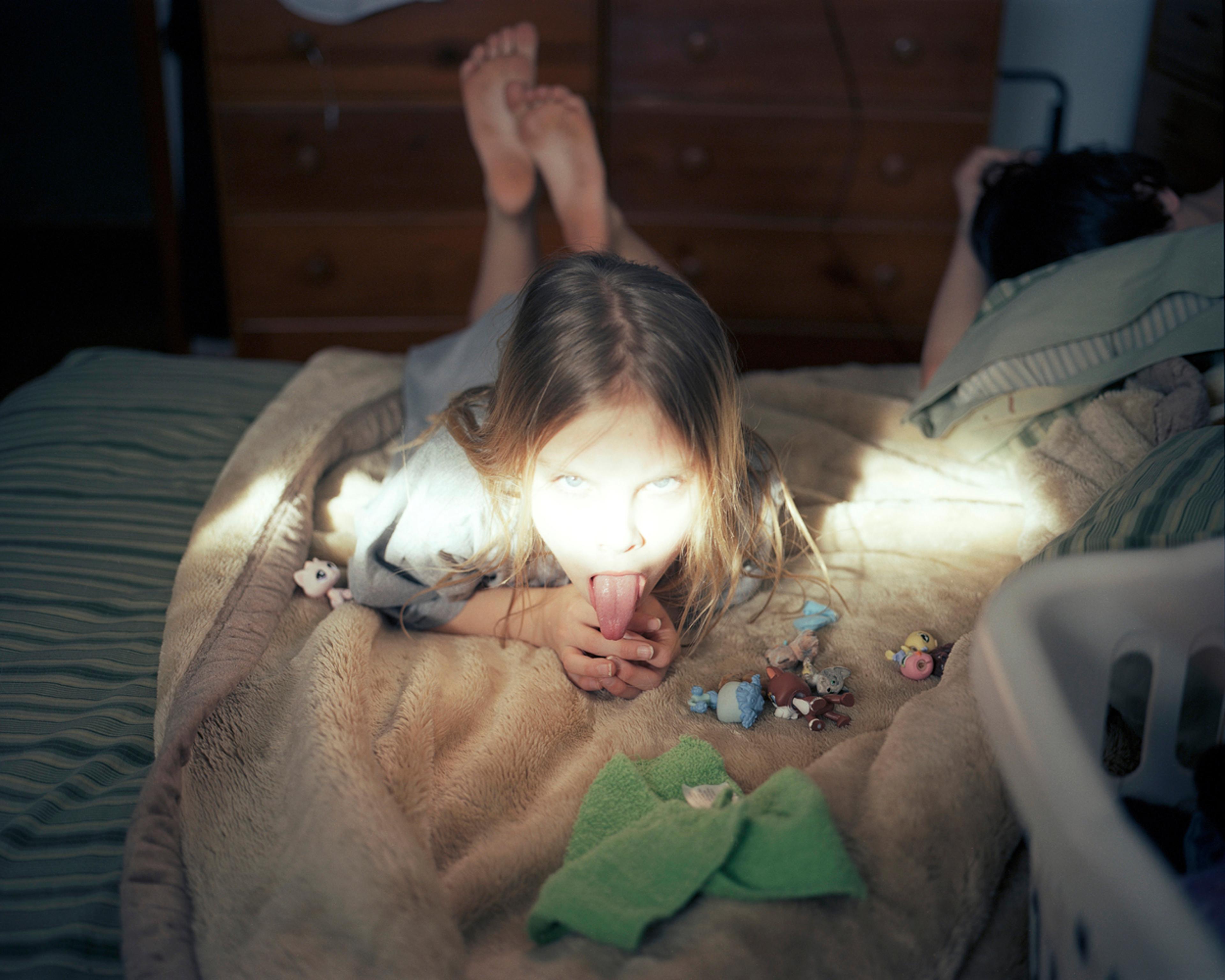 Erica with her toys and a sliver of sunshine. 2008