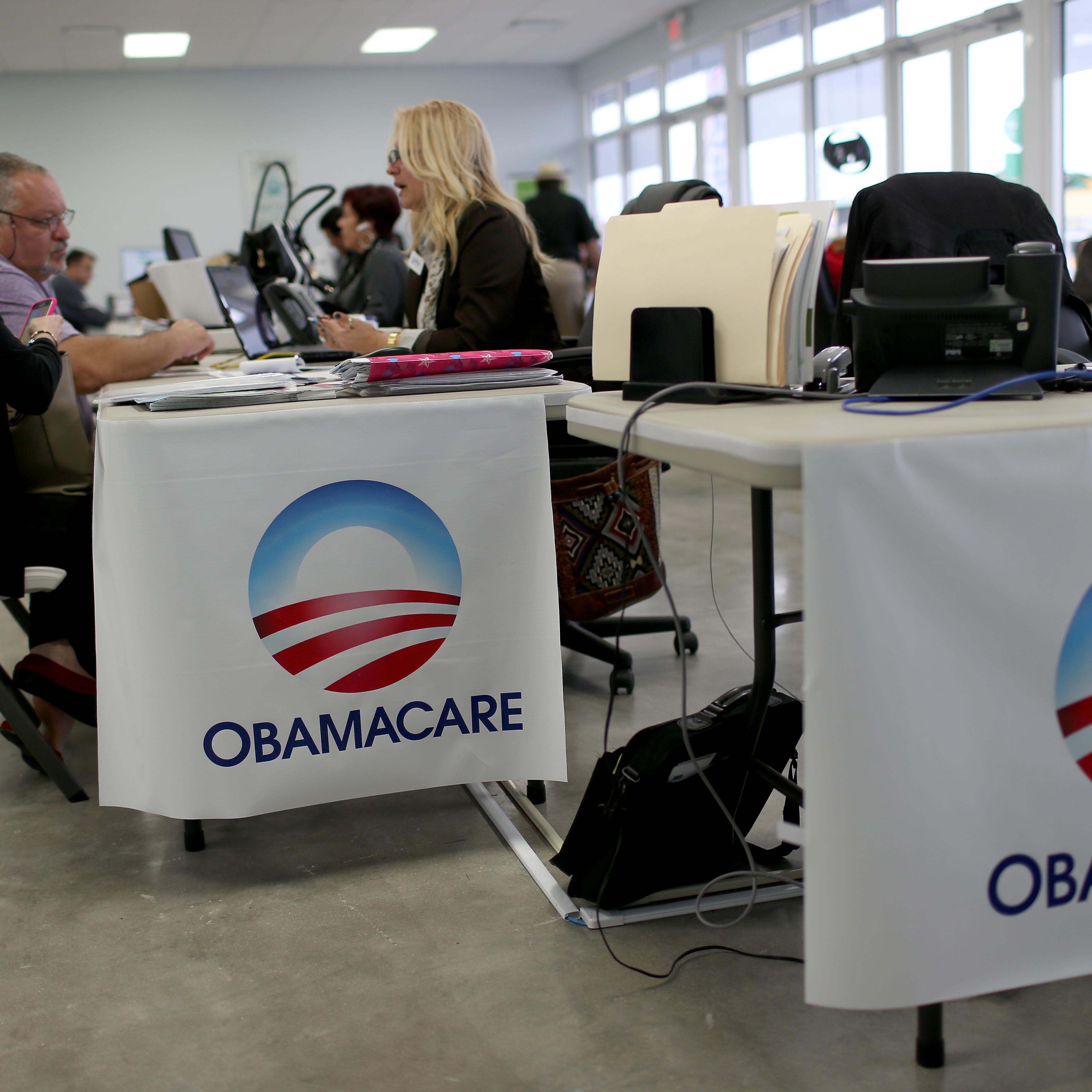 Aymara Marchante (L) and Wiktor Garcia sit with Maria Elena Santa Coloma, an insurance advisor with UniVista Insurance company, as they sign up for the Affordable Care Act, also known as Obamacare, before the February 15th deadline on February 5, 2015 in