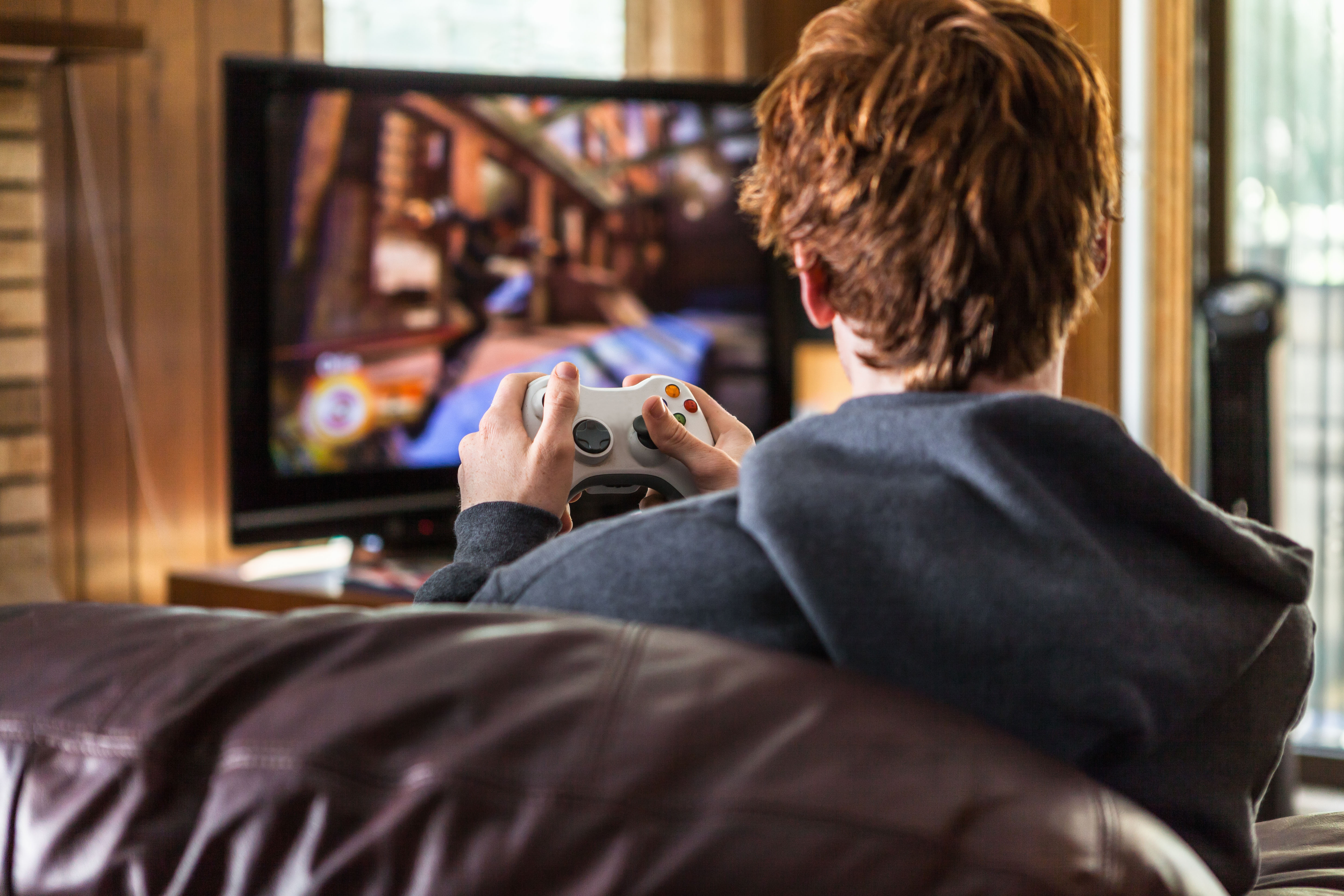 Teenager playing video games