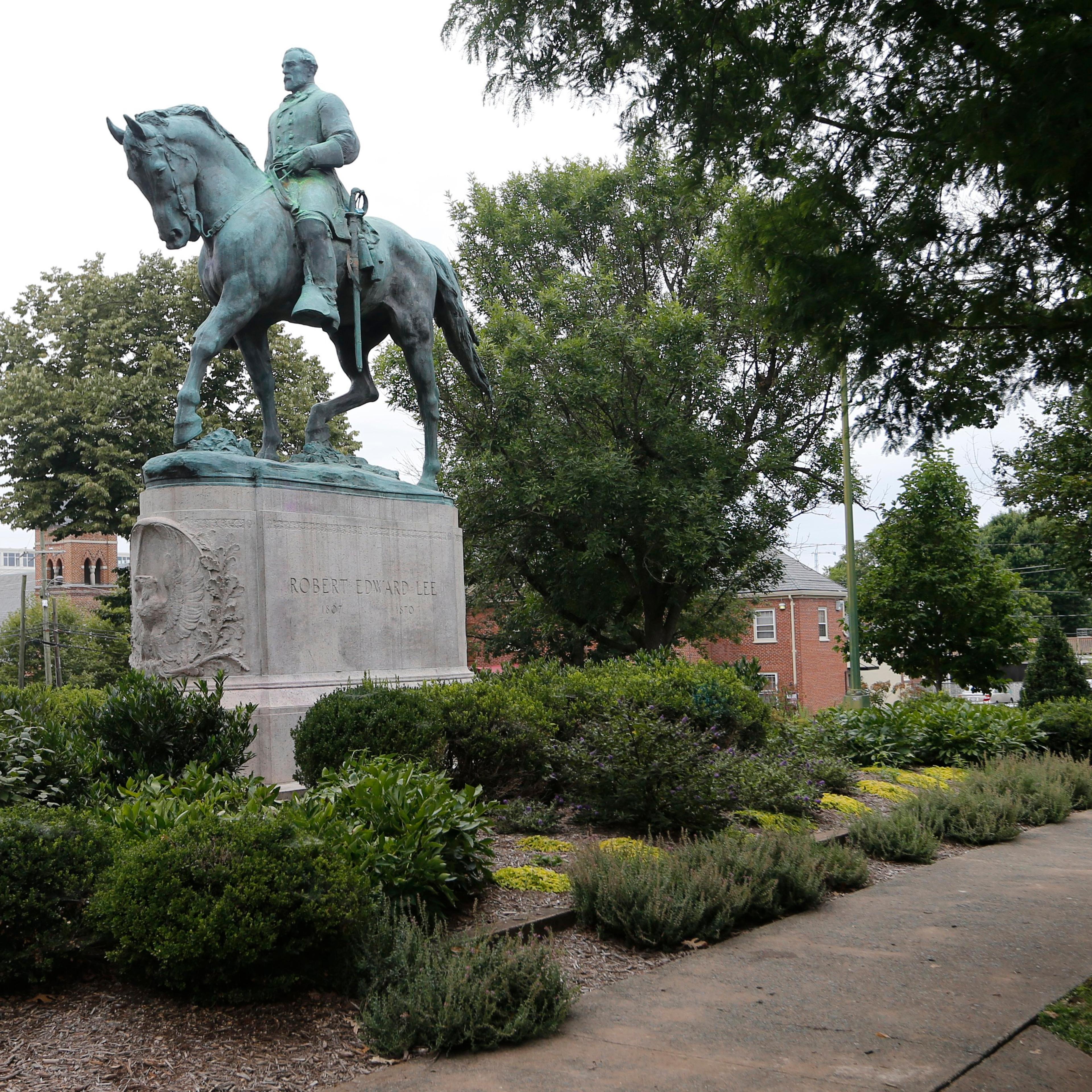 The statue of Confederate General Robert E. Lee still stands in Lee park in Charlottesville, Va. on Aug. 14, 2017.