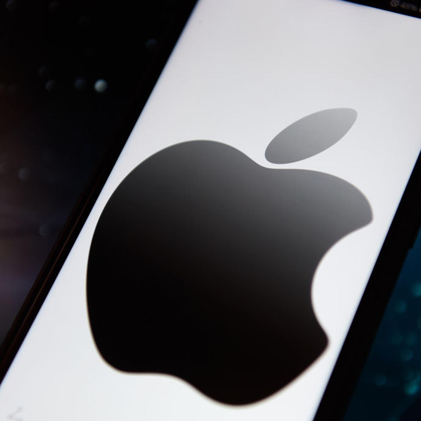 In this photo illustration an Apple logo seen displayed on a