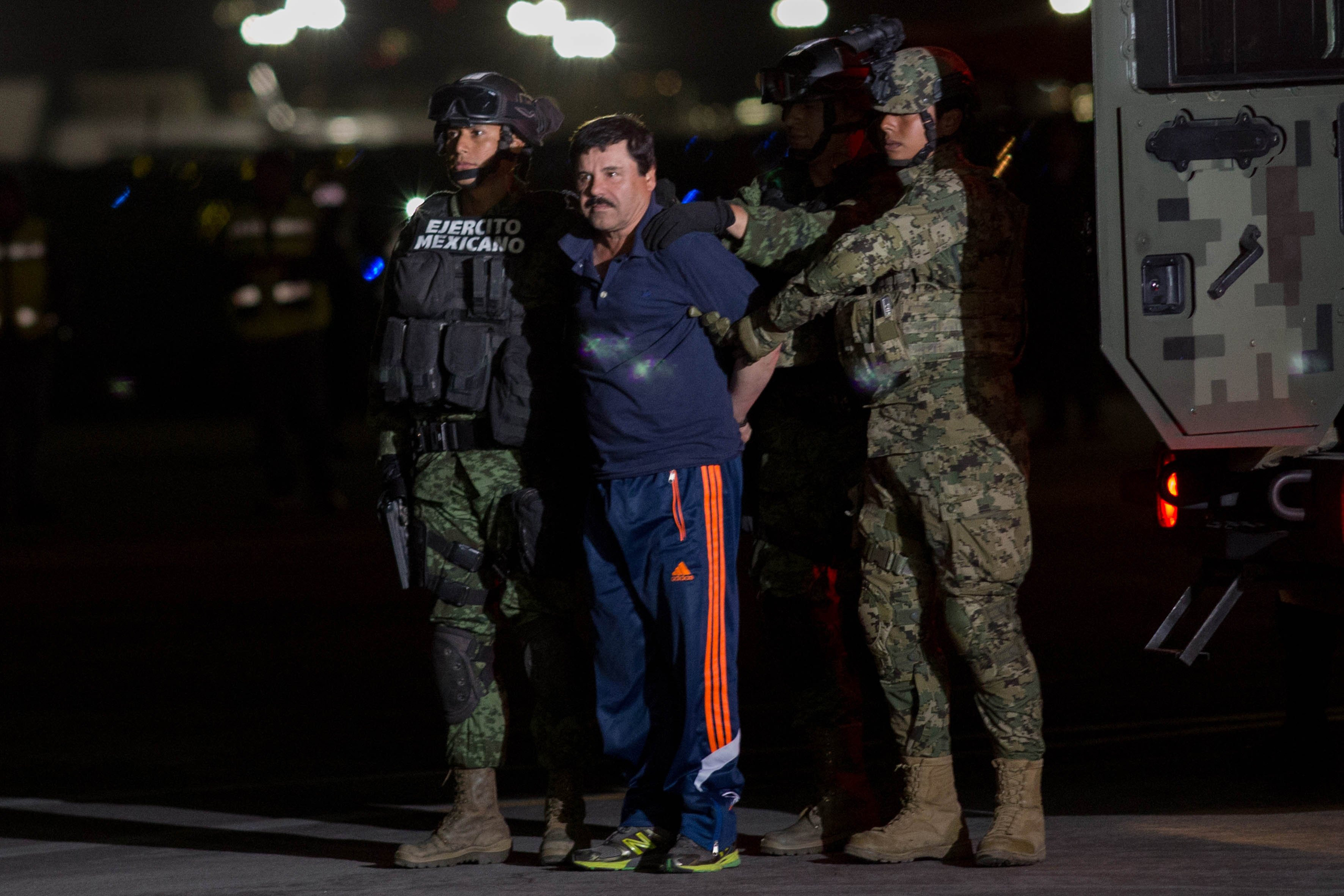 Mexican soldiers escort Joaquín Guzmán upon his arrival in Mexico City after his arrest on Jan. 8