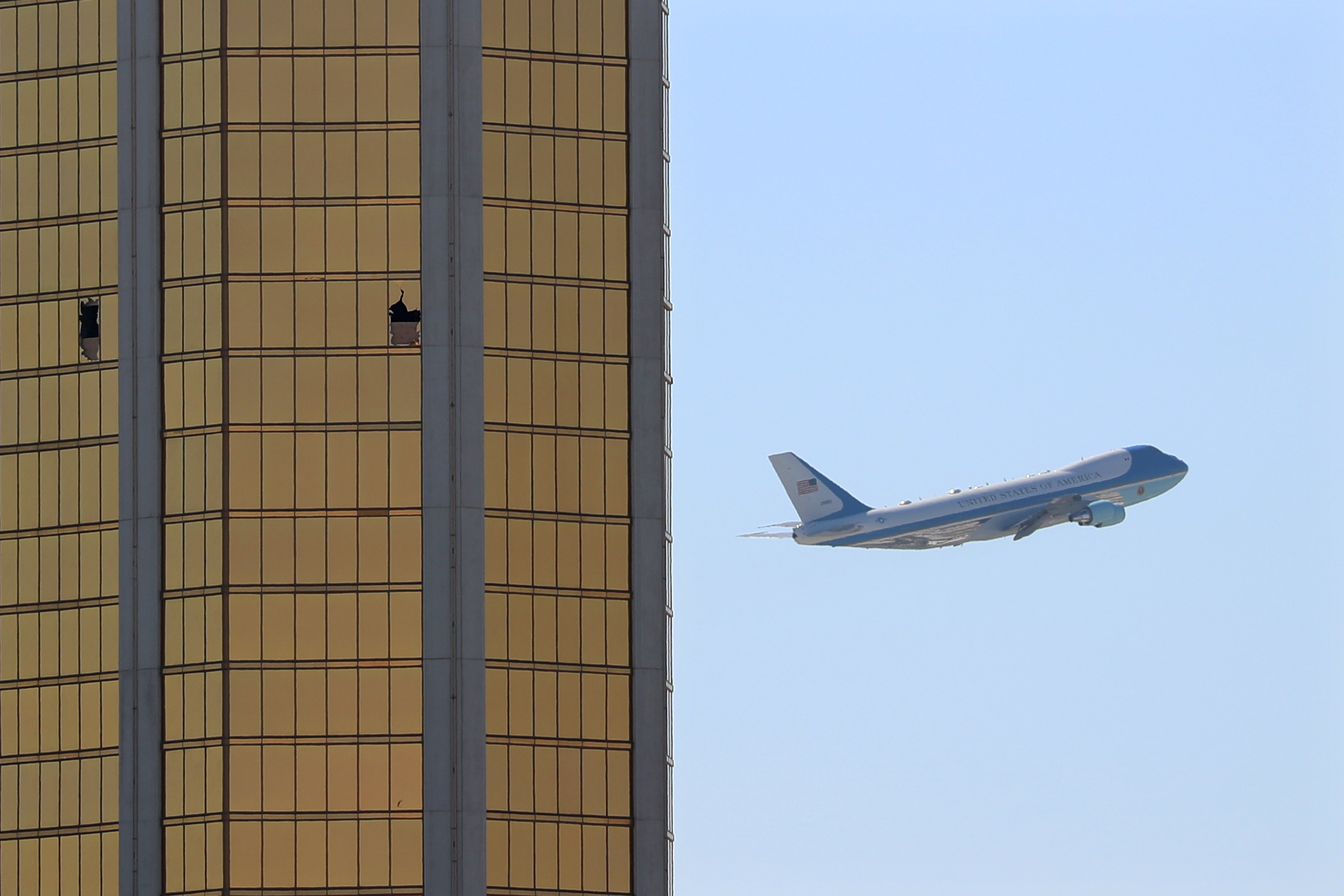 Air Force One departs Las Vegas past the broken windows on the Mandalay Bay hotel, where shooter Stephen Paddock conducted his mass shooting along the Las Vegas Strip in Las Vegas