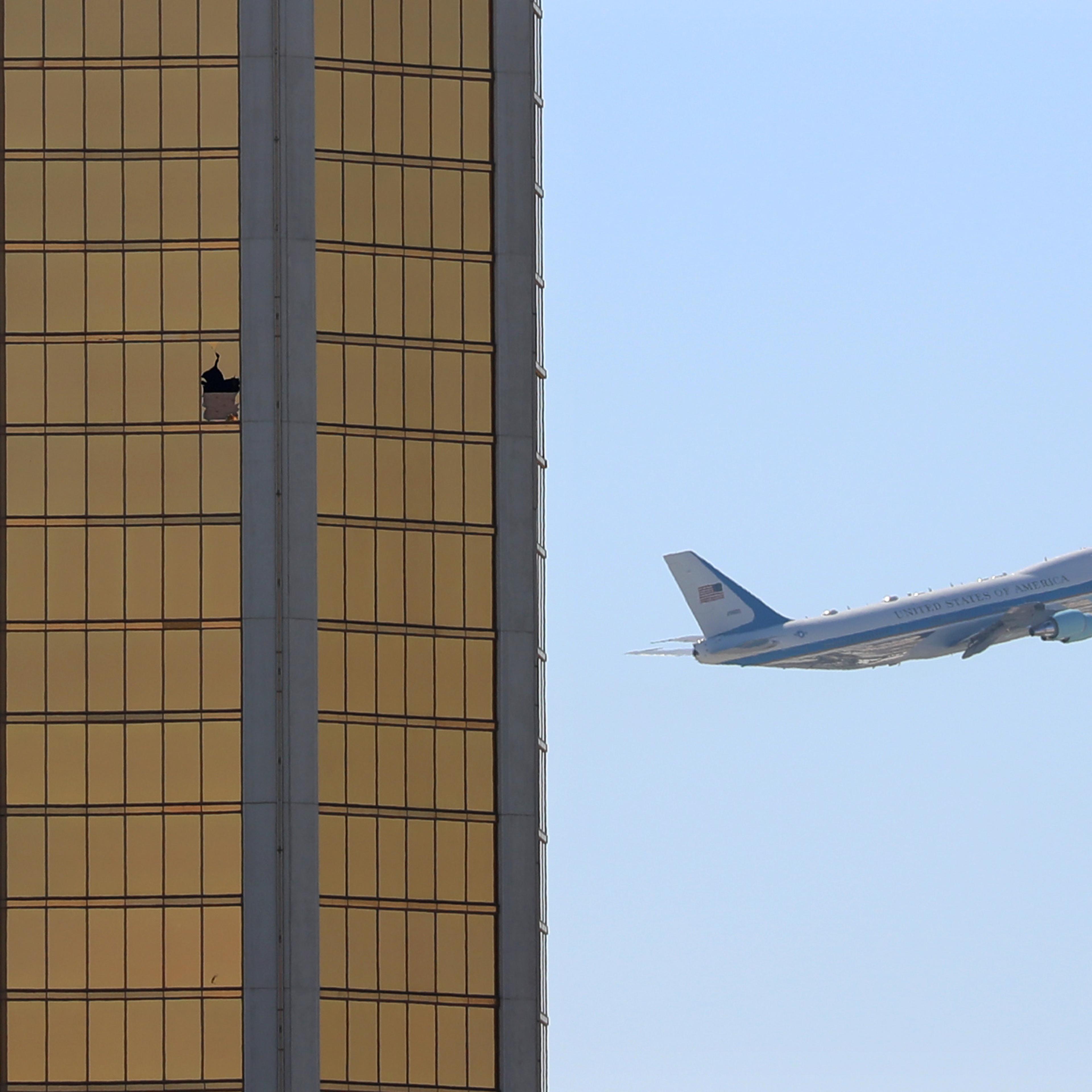 Air Force One departs Las Vegas past the broken windows on the Mandalay Bay hotel, where shooter Stephen Paddock conducted his mass shooting along the Las Vegas Strip in Las Vegas