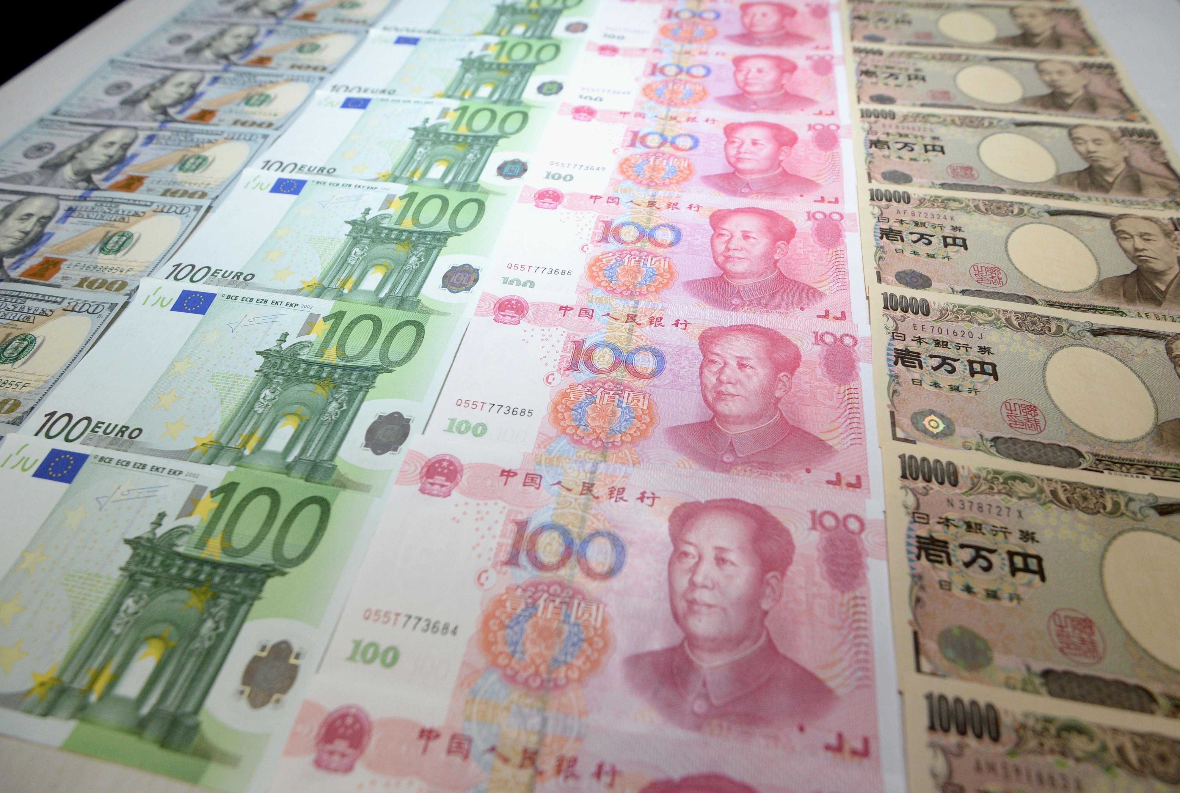 Rows of U.S. dollar, euro, Chinese yuan, and Japanese yen bills, Nov. 30, 2015.