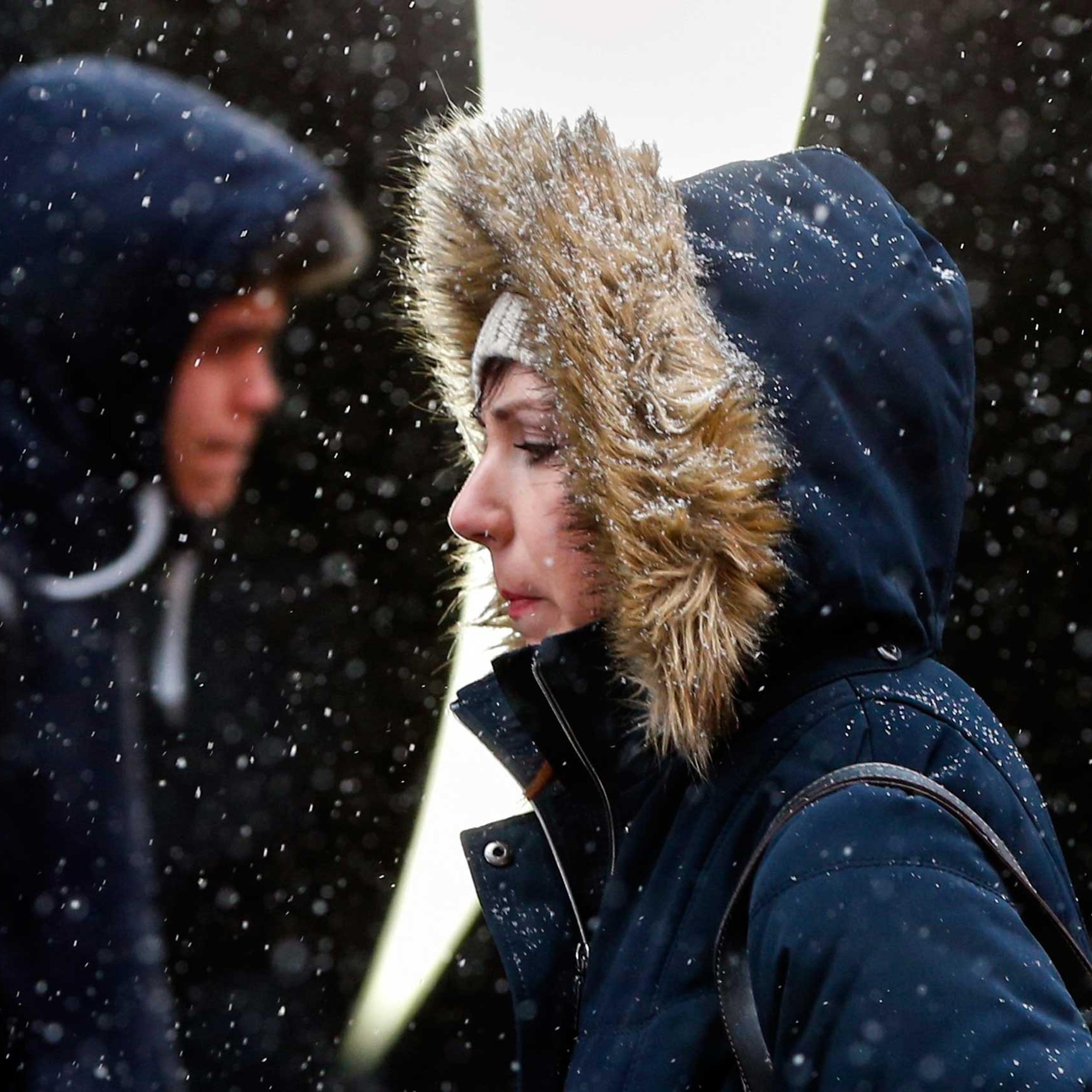 People walk through Times Square during snowfall in New York, March 3, 2015.