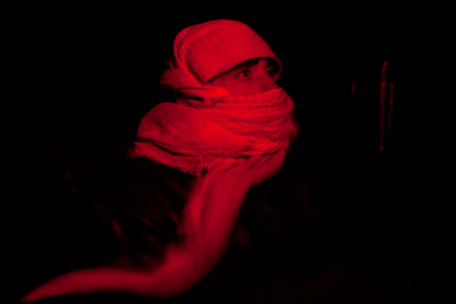 Feb. 22, 2012. A member of the Free Syrian Army rides in the back of a truck in Bab Amr. "We were sitting very close, Rémi and I," Daniels recalls. "Javier [Espinosa, a Spanish reporter] was on my left, and Rémi was on my right. And Rémi took pictures of this guy, but he took the picture with a 24-mm and me with a 35, and we were joking, saying, 'Oh, we will have the same picture, but with different lenses.' Edith was inside the car."