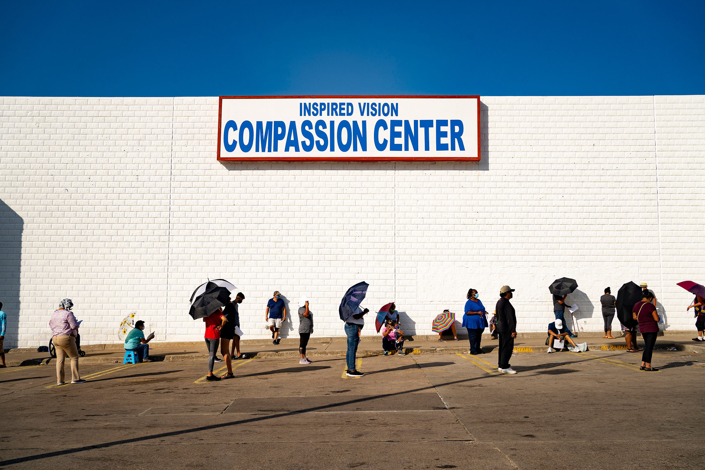 People line up at the Inspired Vision & Compassion Center food bank in Dallas on Aug. 14