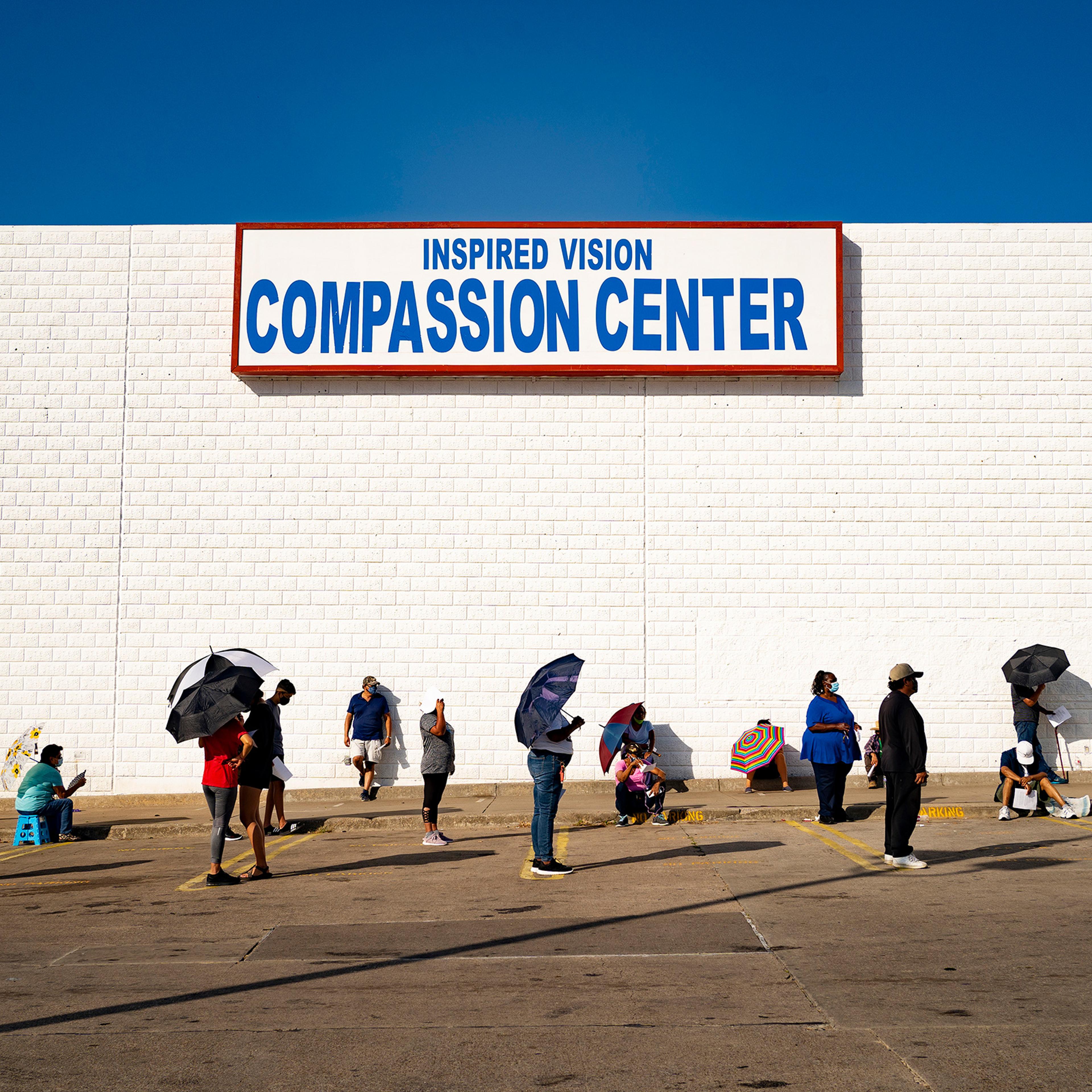 People line up at the Inspired Vision & Compassion Center food bank in Dallas on Aug. 14