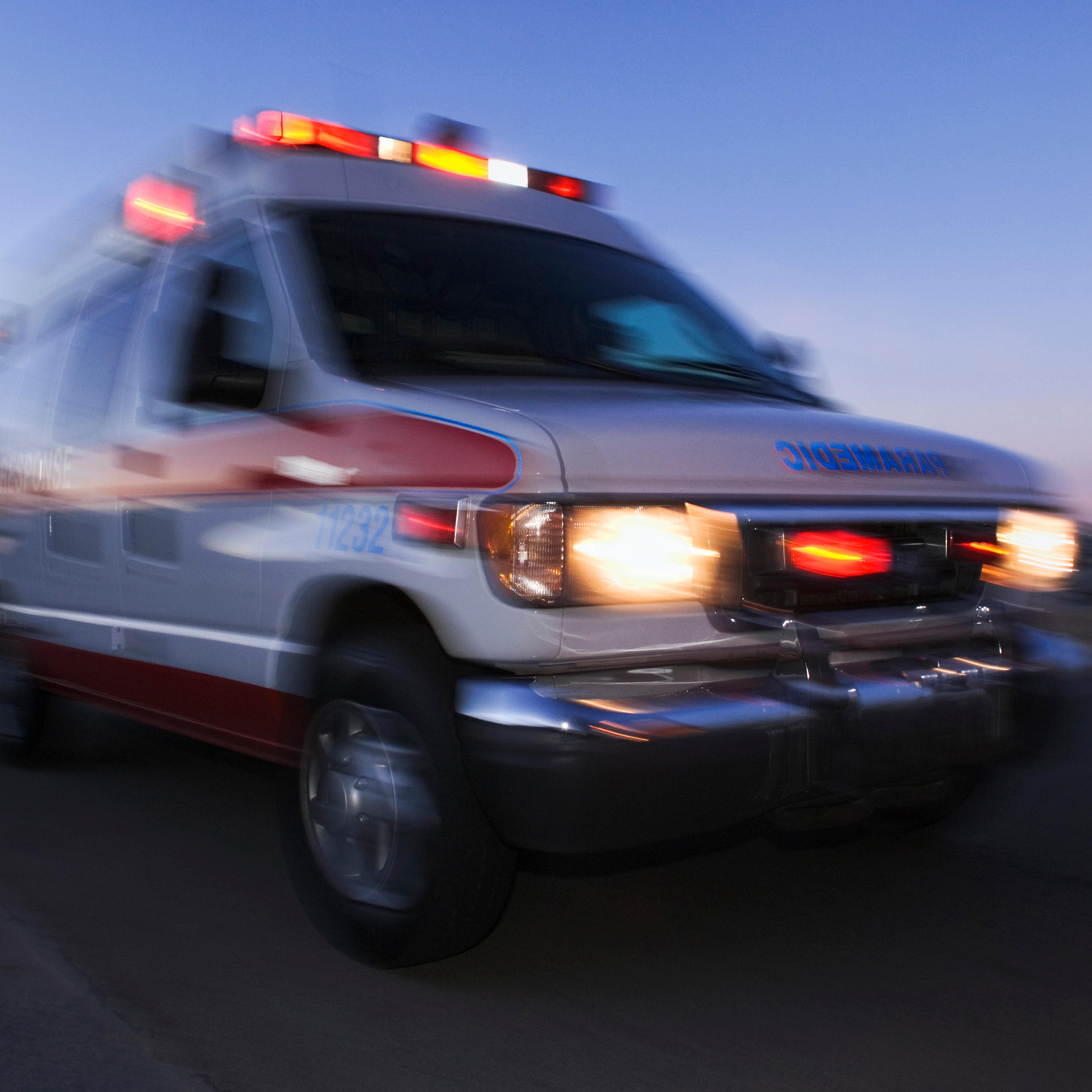 Blurred view of ambulance driving at dusk