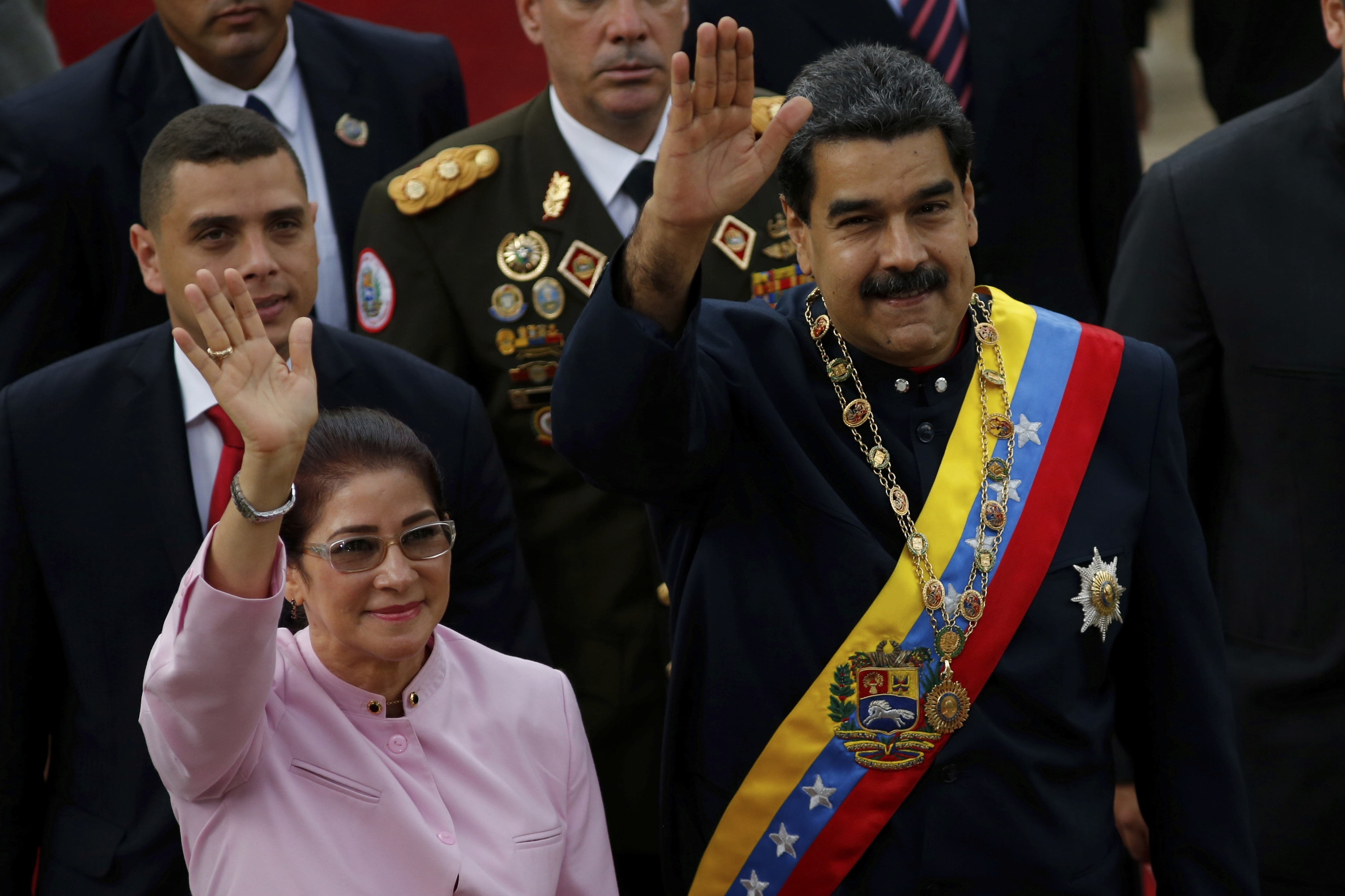 Venezuela's President Nicolas Maduro, right, and his wife Cilia Flores wave as they arrive to the National Assembly building for a session of the Constitutional Assembly in Caracas, Venezuela, Aug. 10, 2017.