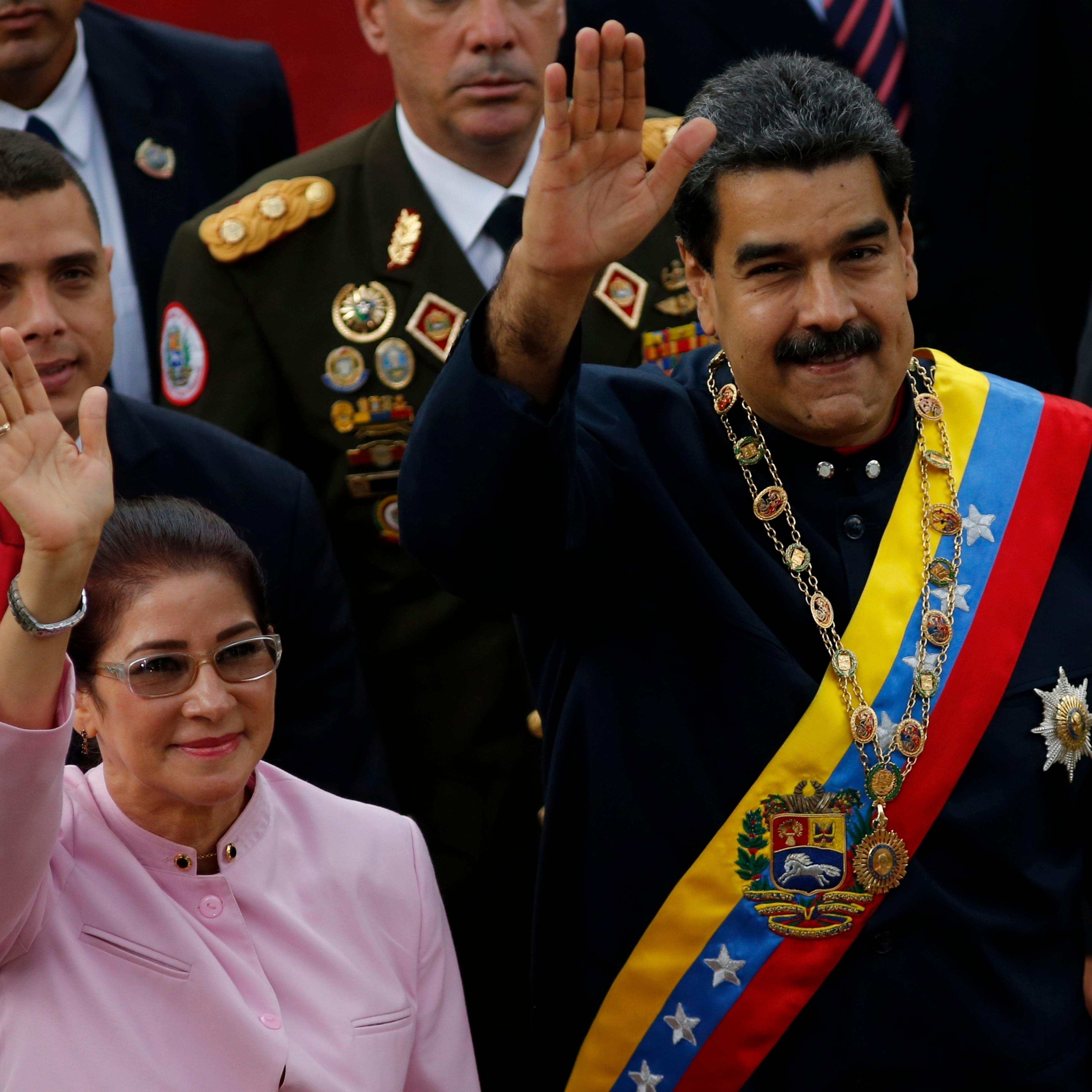 Venezuela's President Nicolas Maduro, right, and his wife Cilia Flores wave as they arrive to the National Assembly building for a session of the Constitutional Assembly in Caracas, Venezuela, Aug. 10, 2017.