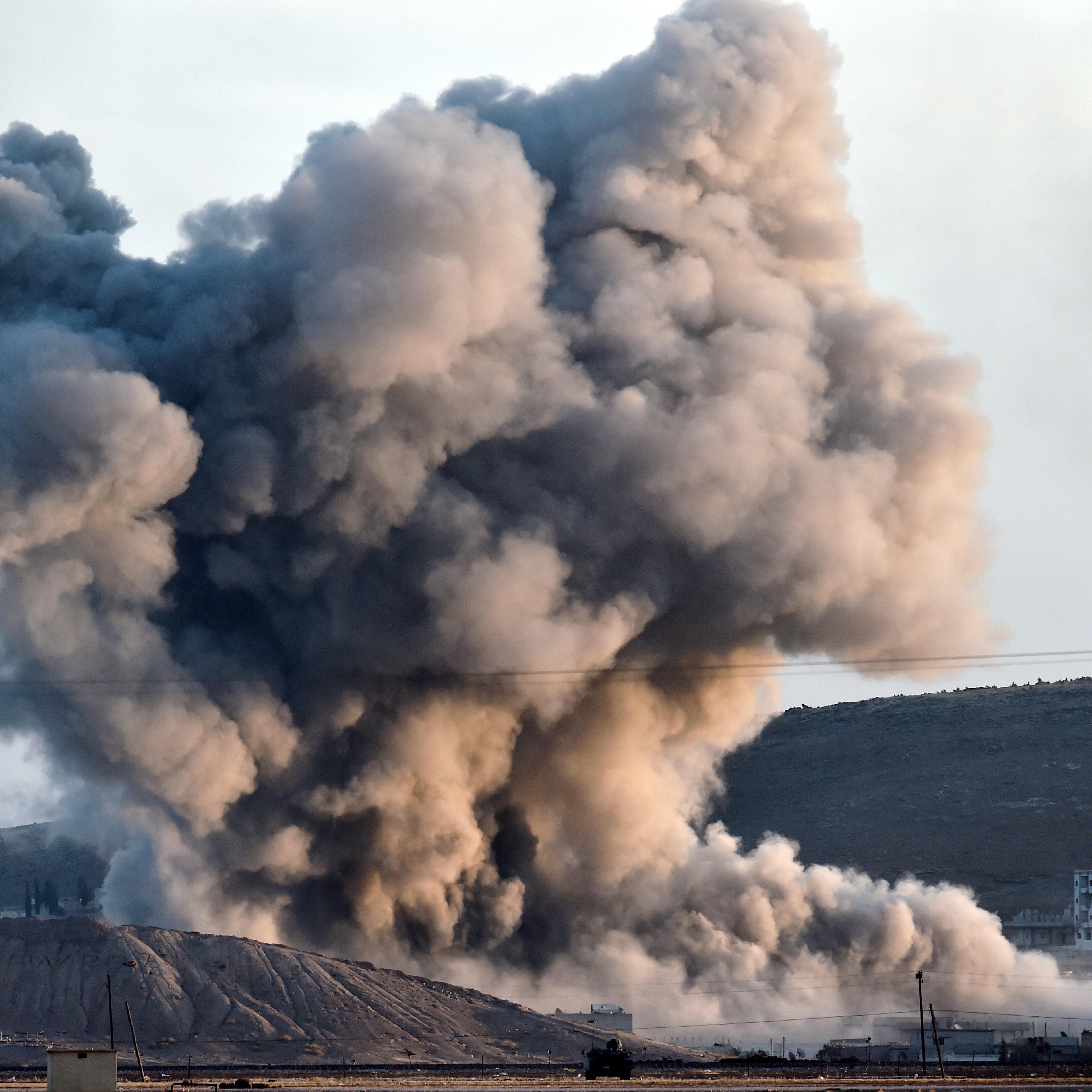 An allied air strike hits a hill in Kobani Wednesday near where ISIS fighters had planted their flag.