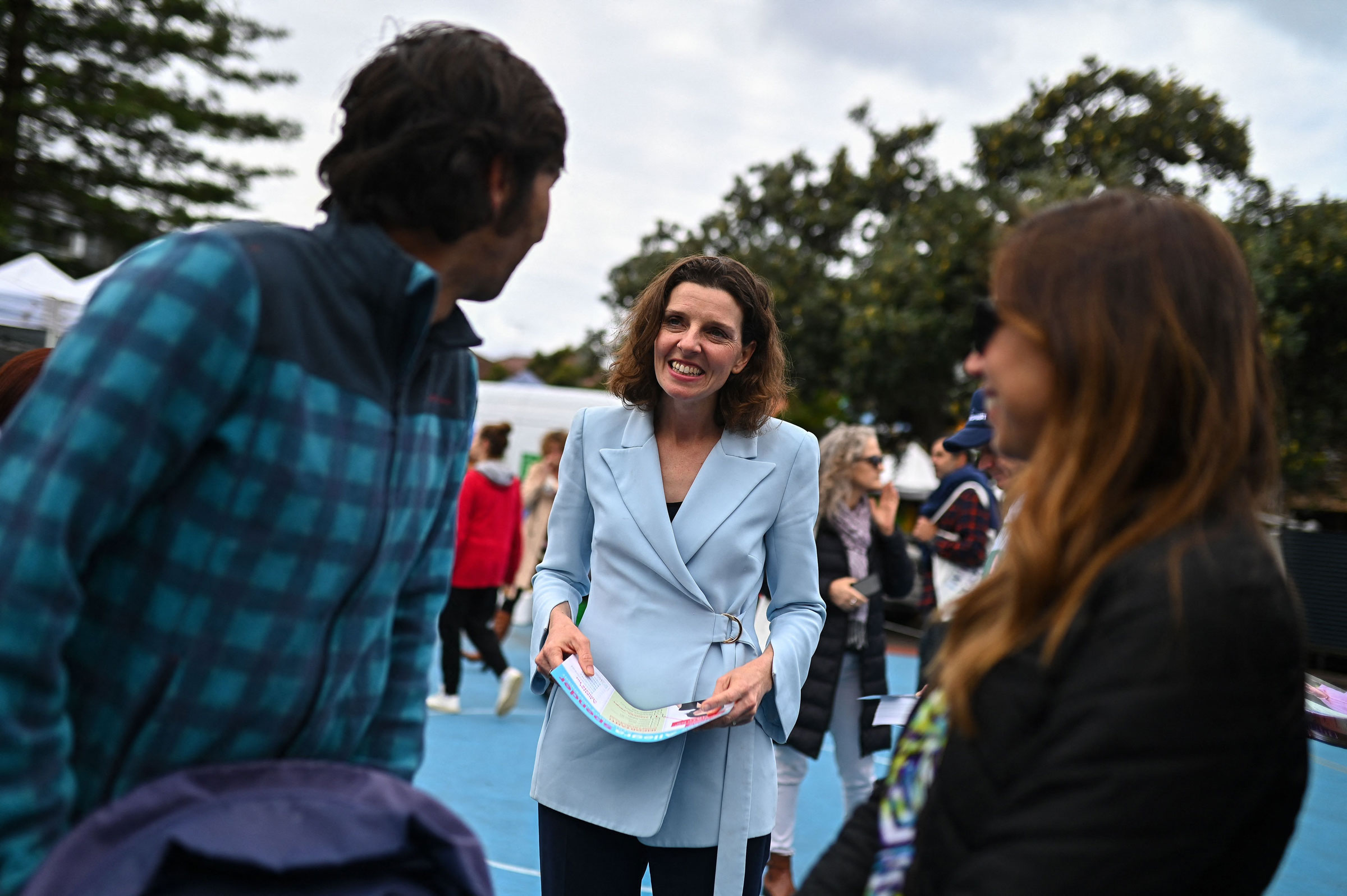 Allegra Spender speaks to voters at a polling station