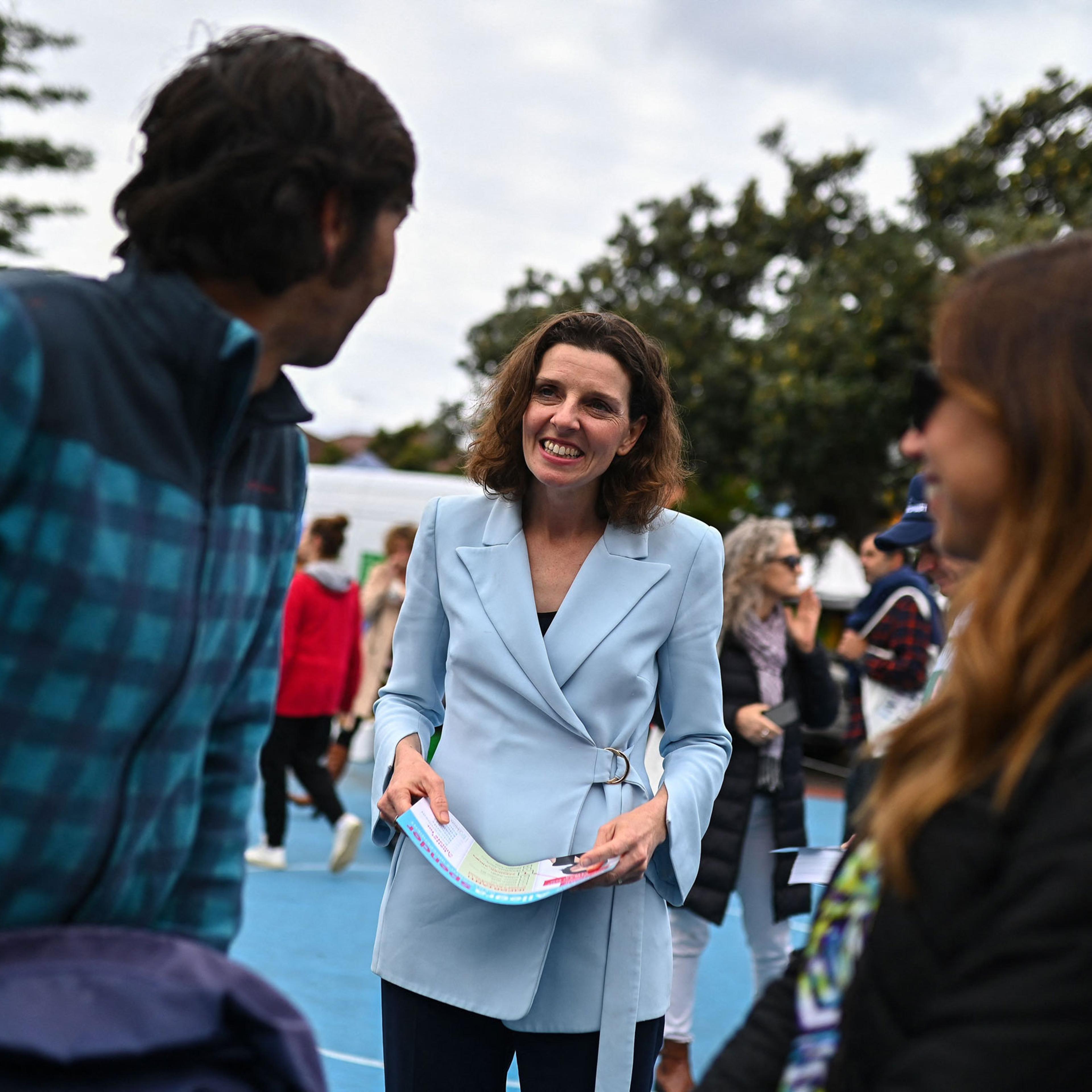 Allegra Spender speaks to voters at a polling station