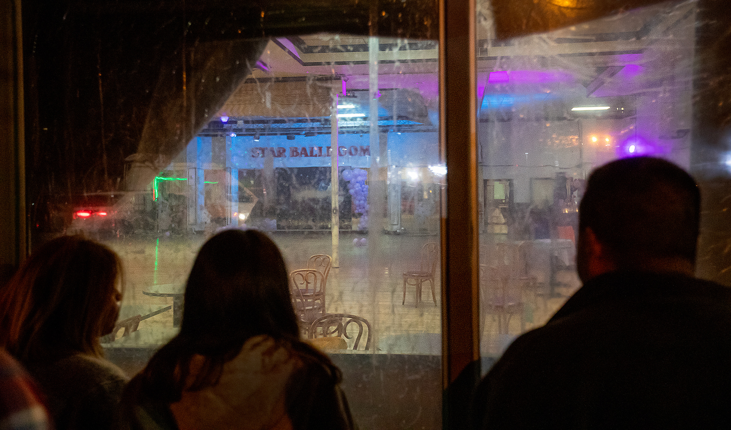After police tape was taken down, curious bystanders view the crime scene inside the Star Dance Studio Ballroom in Monterey Park, Calif. on Jan. 22.  