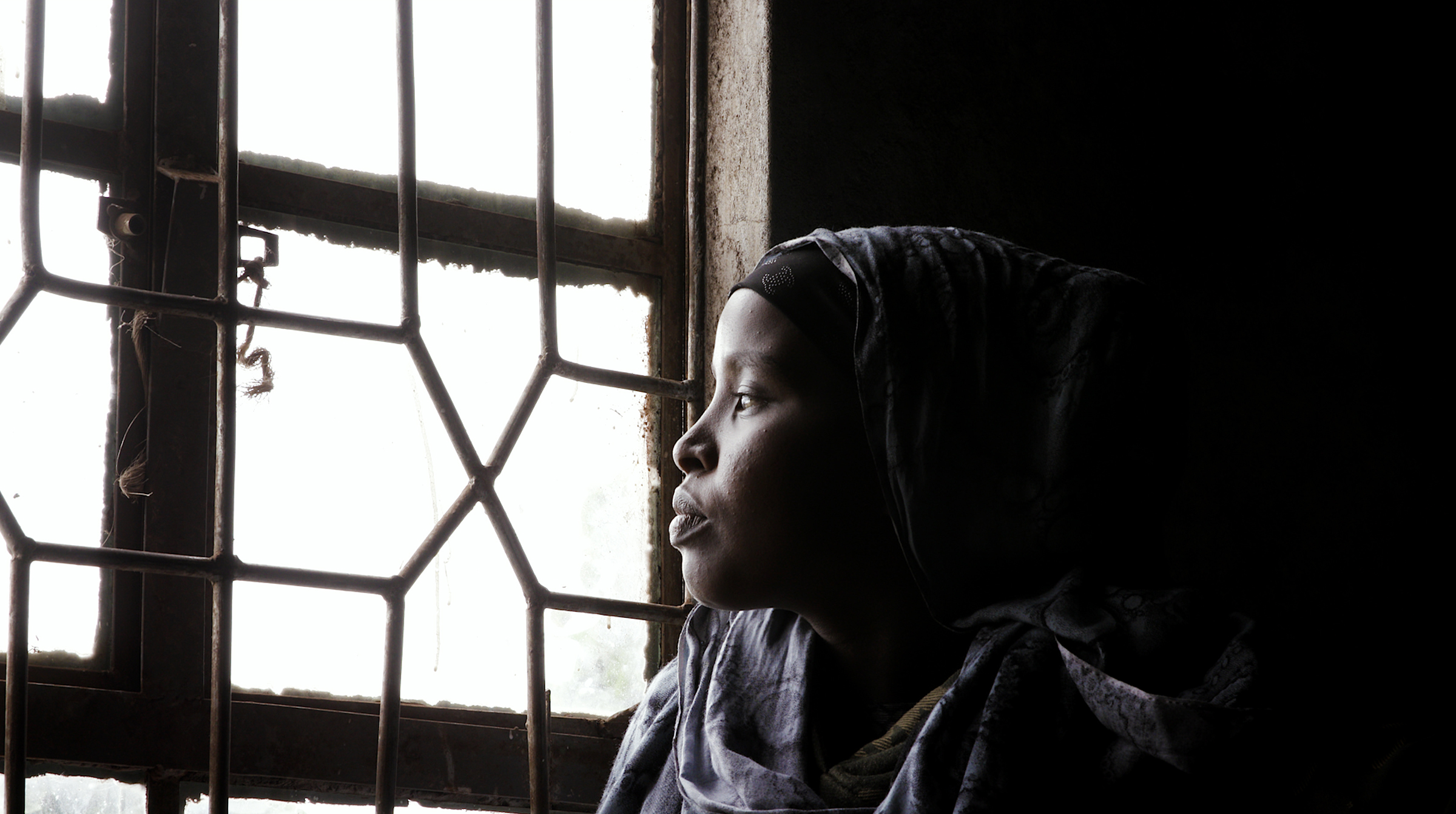 This frame grab from a video taken for TIME on 15 March 2020, shows Gumato Kuni lookng outside the window of her home in Marsabit. She is a child bride whose parents married her when she was 15 years old after her family's livestock were devastated by se