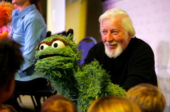 Caroll Spinney, the puppeteer who brings to life characters such as Oscar the Grouch and Big Bird, entertains children at a promotion for 'Sesame Street: A Celebration Of 40 Years Of Life On The Street'