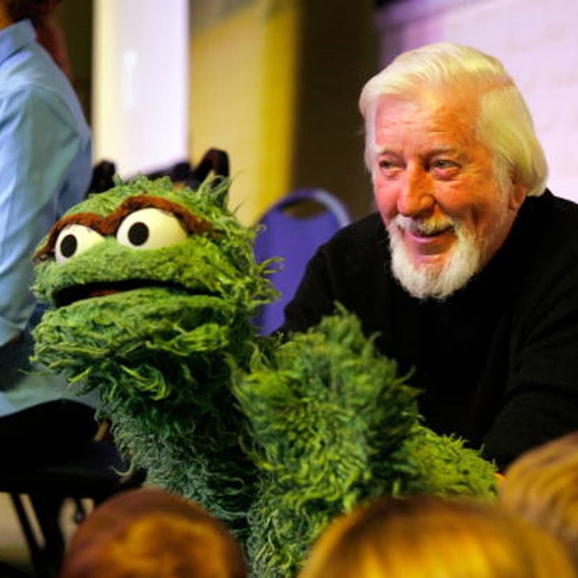 Caroll Spinney, the puppeteer who brings to life characters such as Oscar the Grouch and Big Bird, entertains children at a promotion for 'Sesame Street: A Celebration Of 40 Years Of Life On The Street'