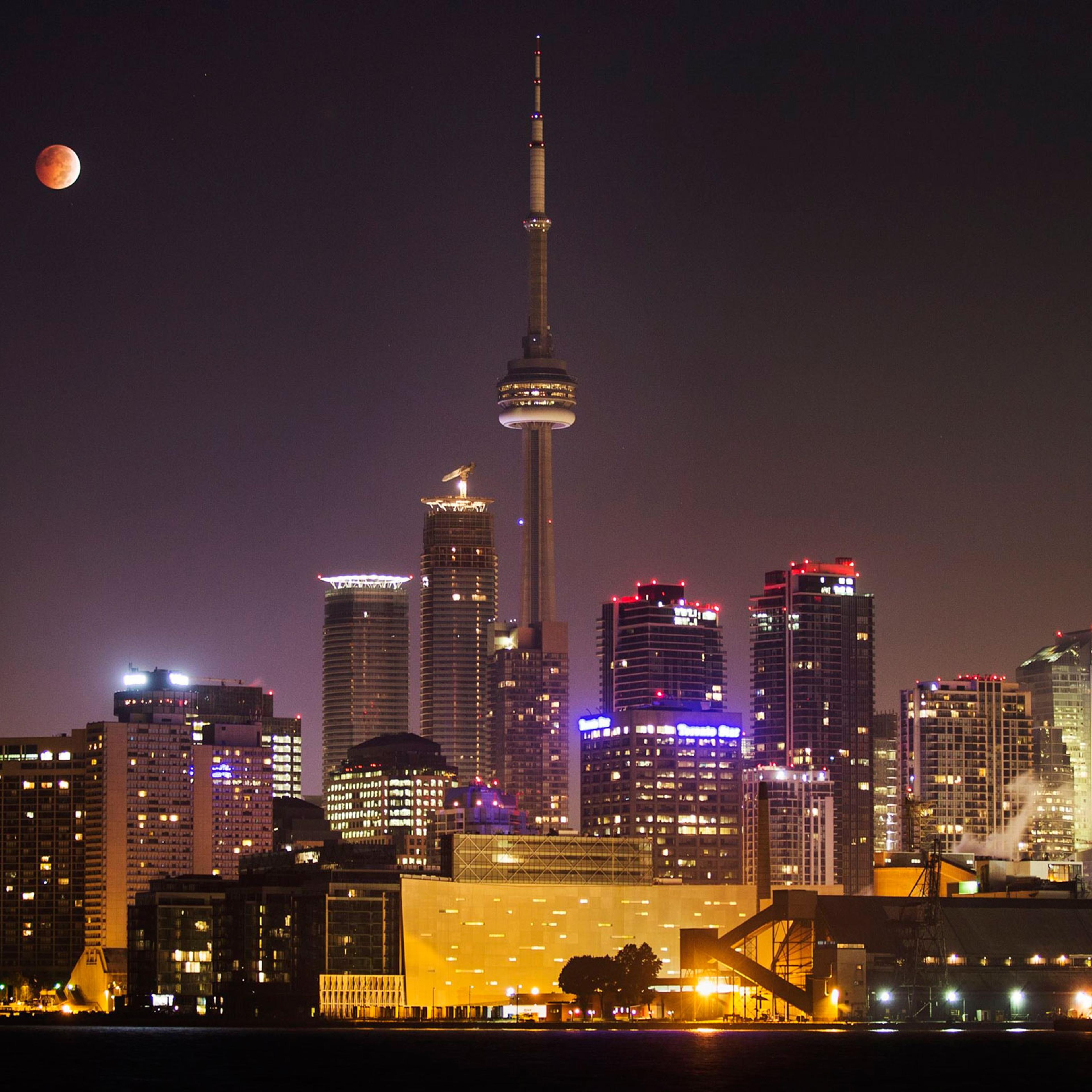 The moon during a total lunar eclipse behind the CN Tower and the skyline of Toronto on Oct. 8, 2014.