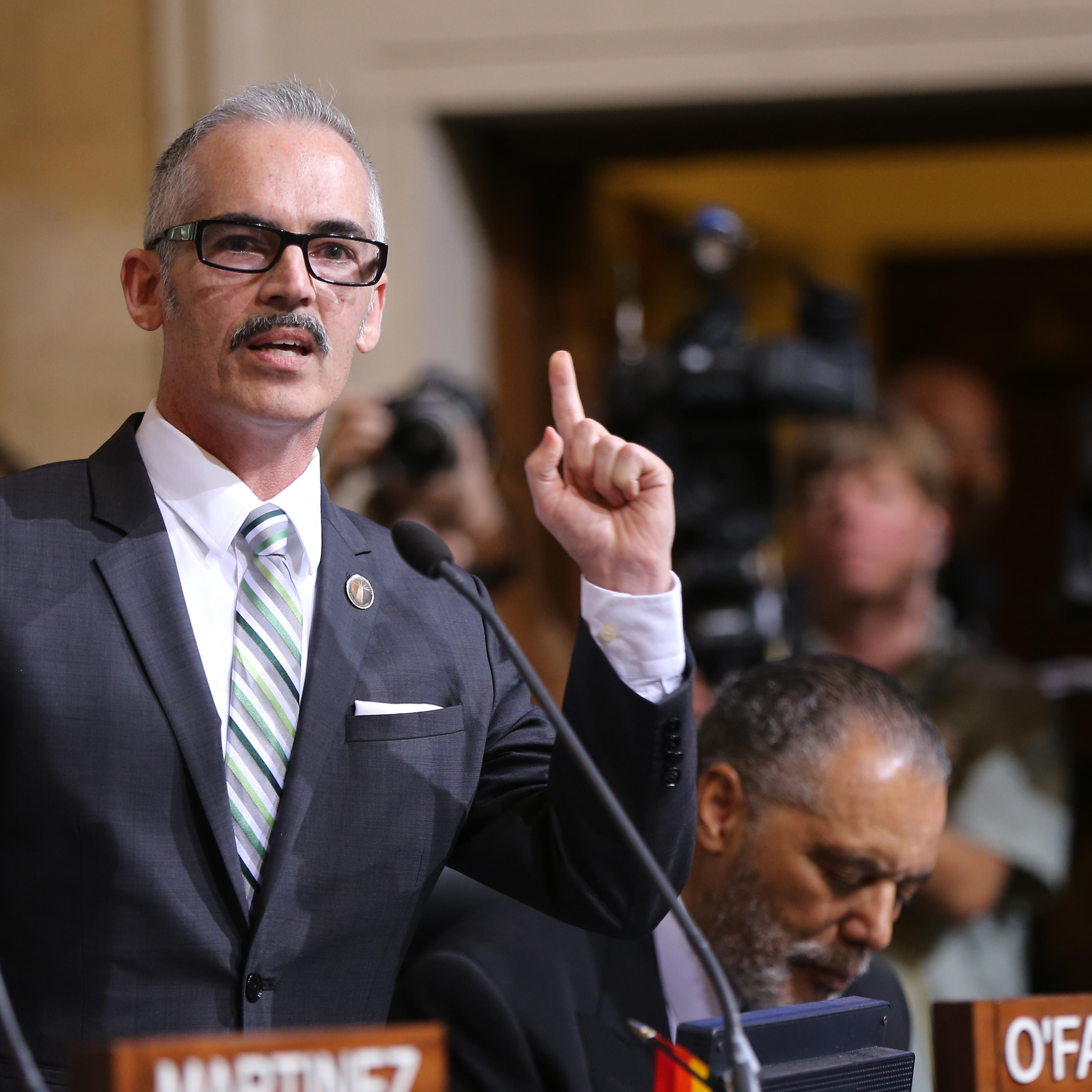 Los Angeles Council member Mitch O'Farrell, left, expresses his support to raise the minimum wage on May 19, 2015, in Los Angeles.