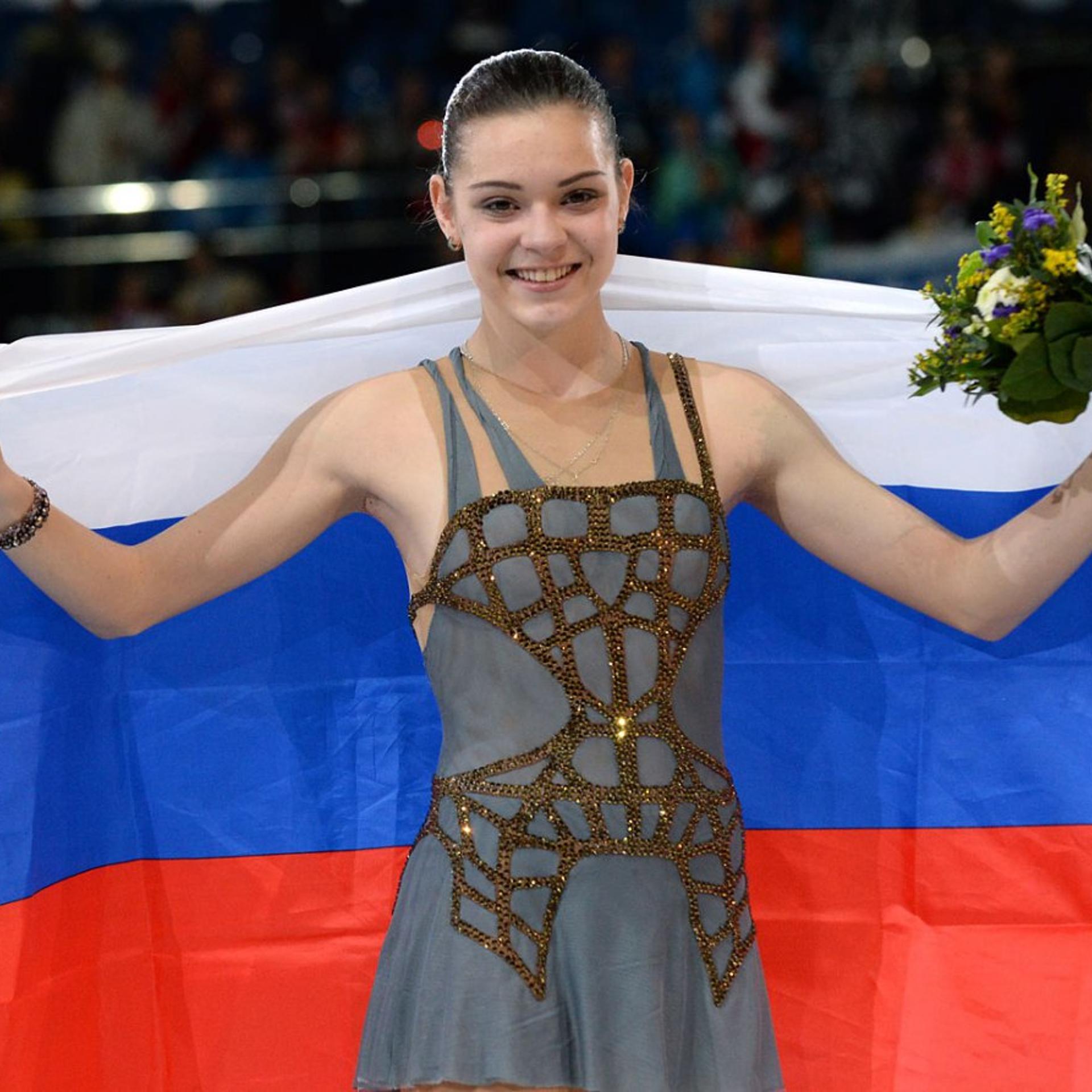 Russia's gold medalist Adelina Sotnikova celebrates during the Women's Figure Skating Flower Ceremony at the Iceberg Skating Palace during the Sochi Winter Olympics on February 20, 2014.