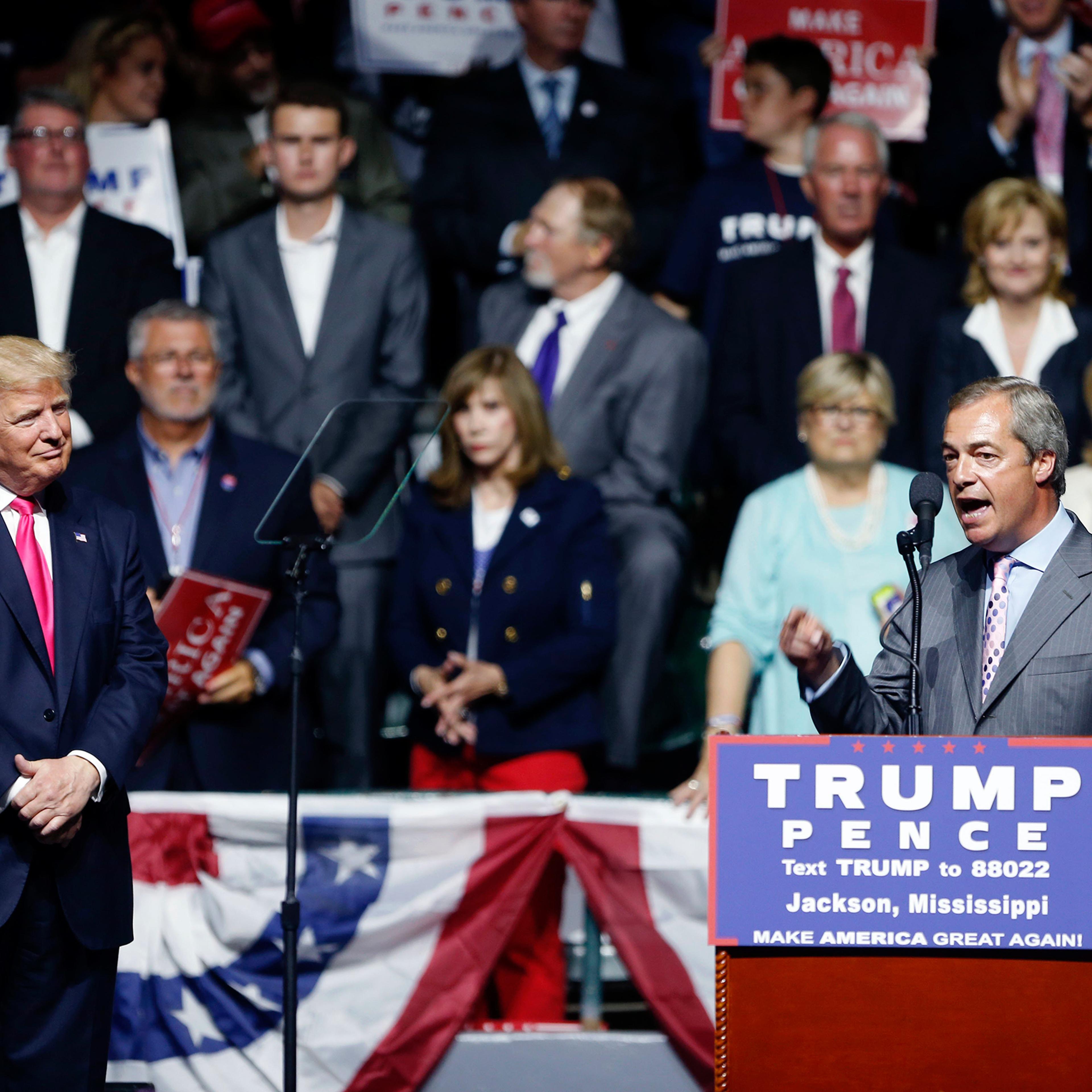 Nigel Farage, ex-leader of the British UKIP party, speaks as Republican presidential candidate Donald Trump listens at Trump's campaign rally in Jackson, Miss., on Aug. 24, 2016.