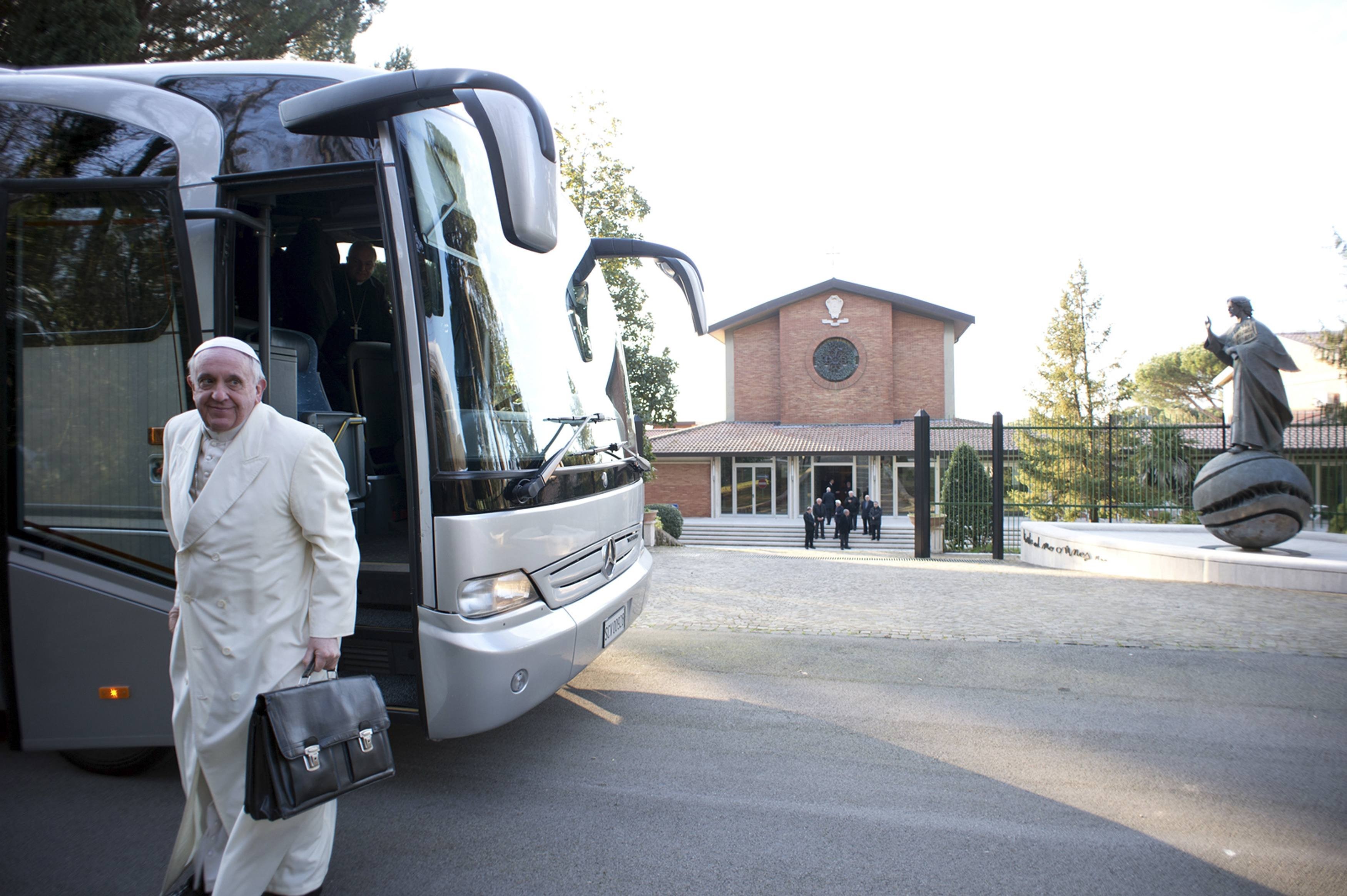 Pope Francis alights from a bus with other cardinals and bishops for a retreat in Ariccia