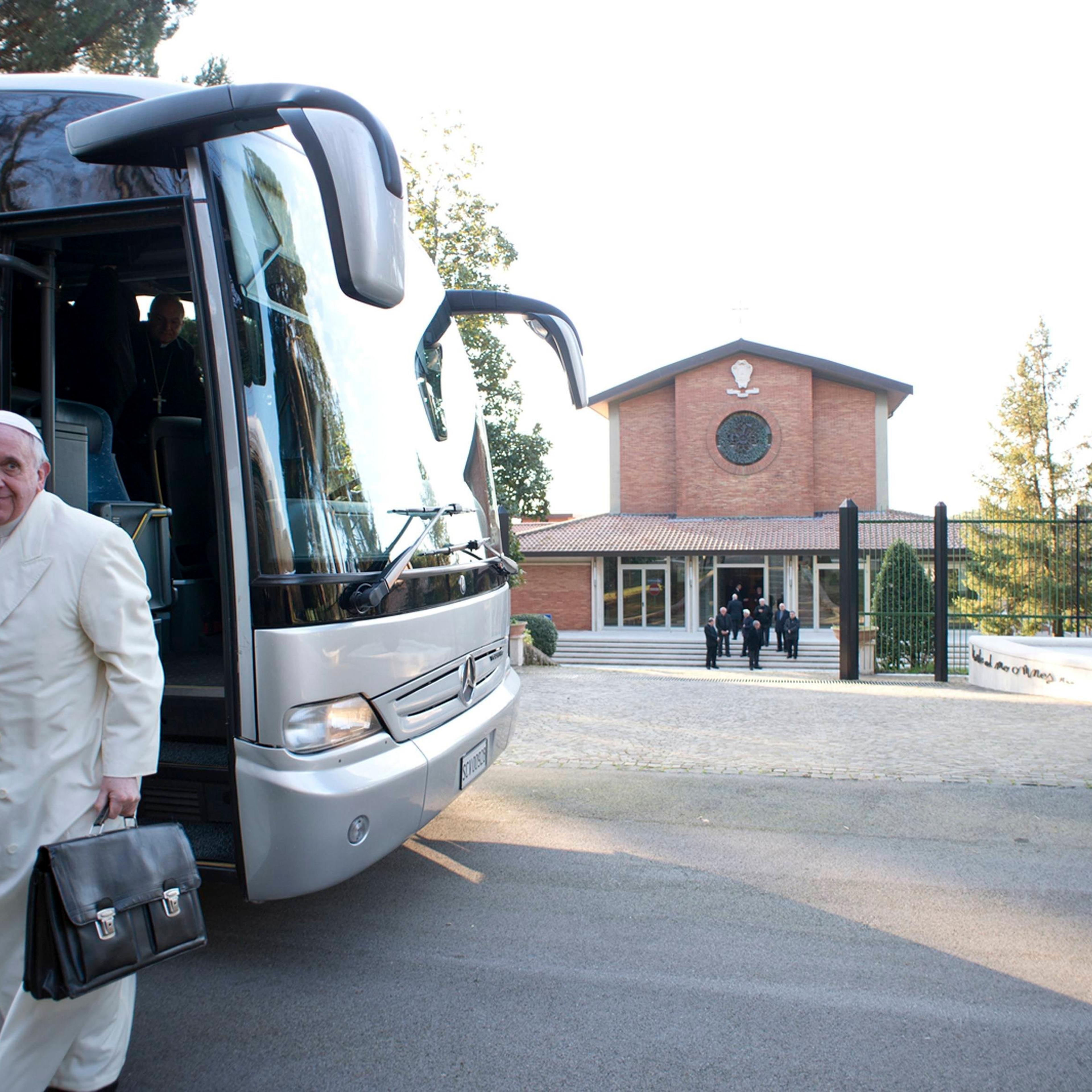 Pope Francis alights from a bus with other cardinals and bishops for a retreat in Ariccia