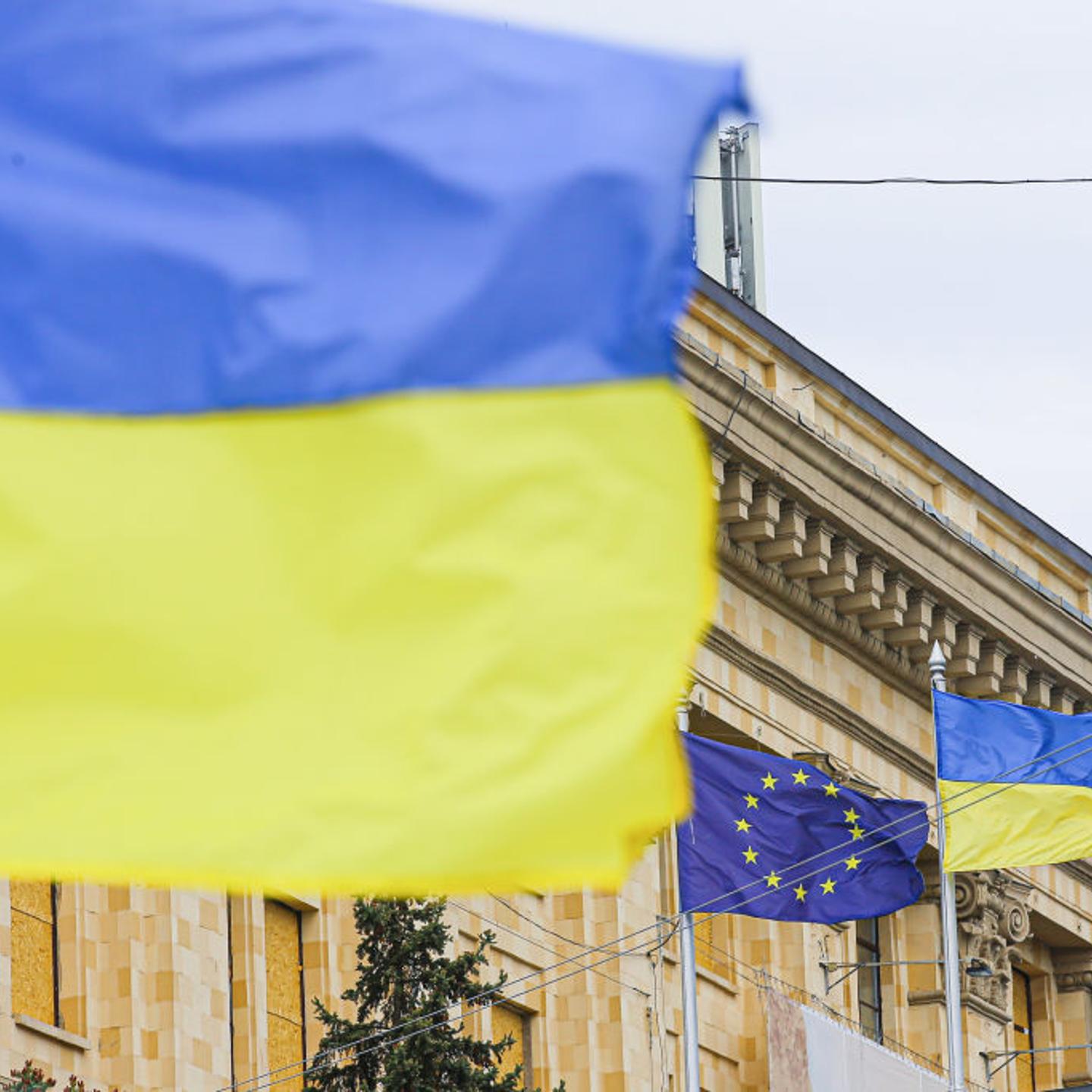 Ukrainian and EU flags in front of the Kharkiv Regional