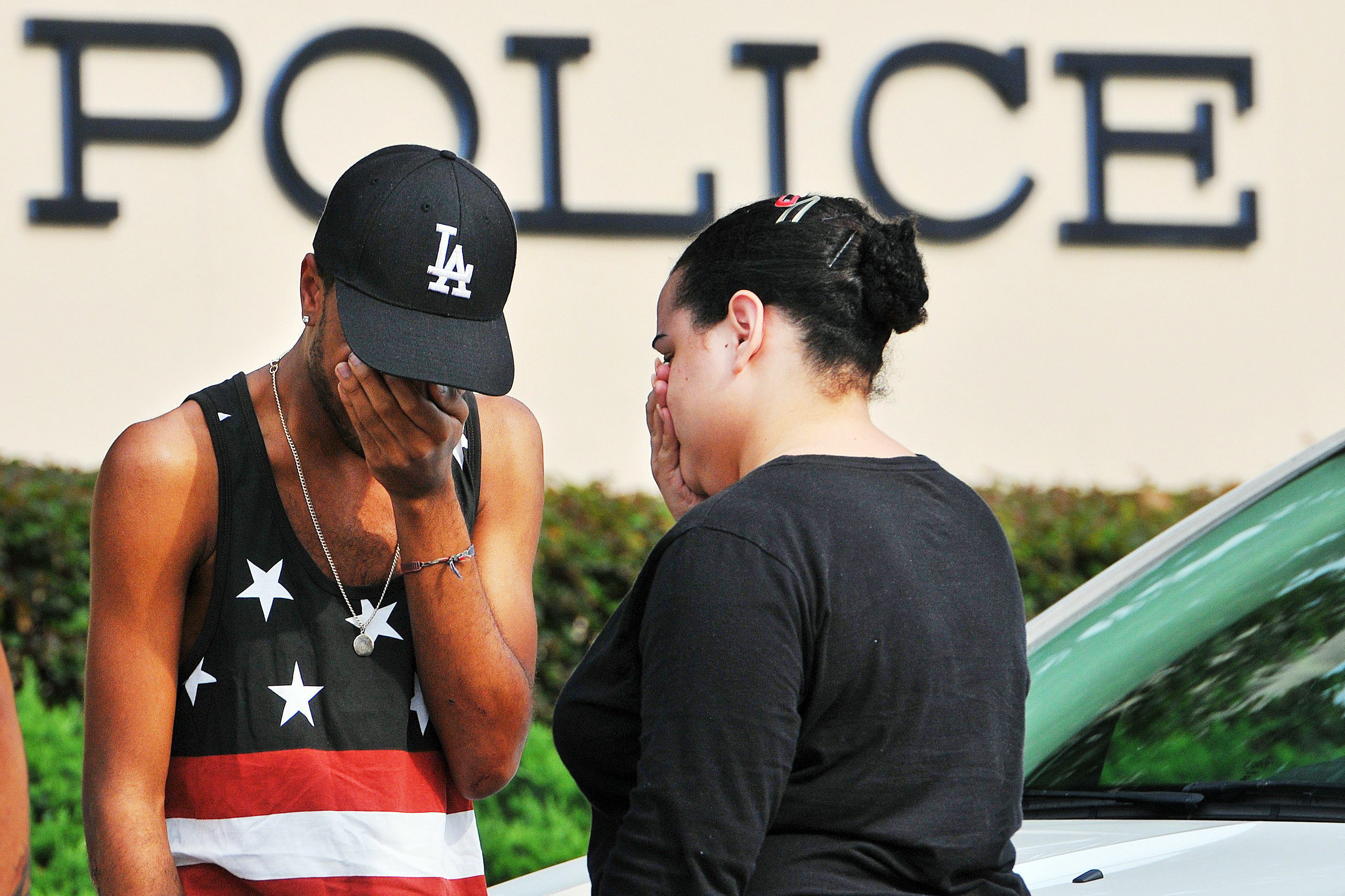 Victims and witnesses make their way out of the Orlando police headquarters building following an attack at the Pulse nightclub on June 12, 2016 in Orlando, Fla.