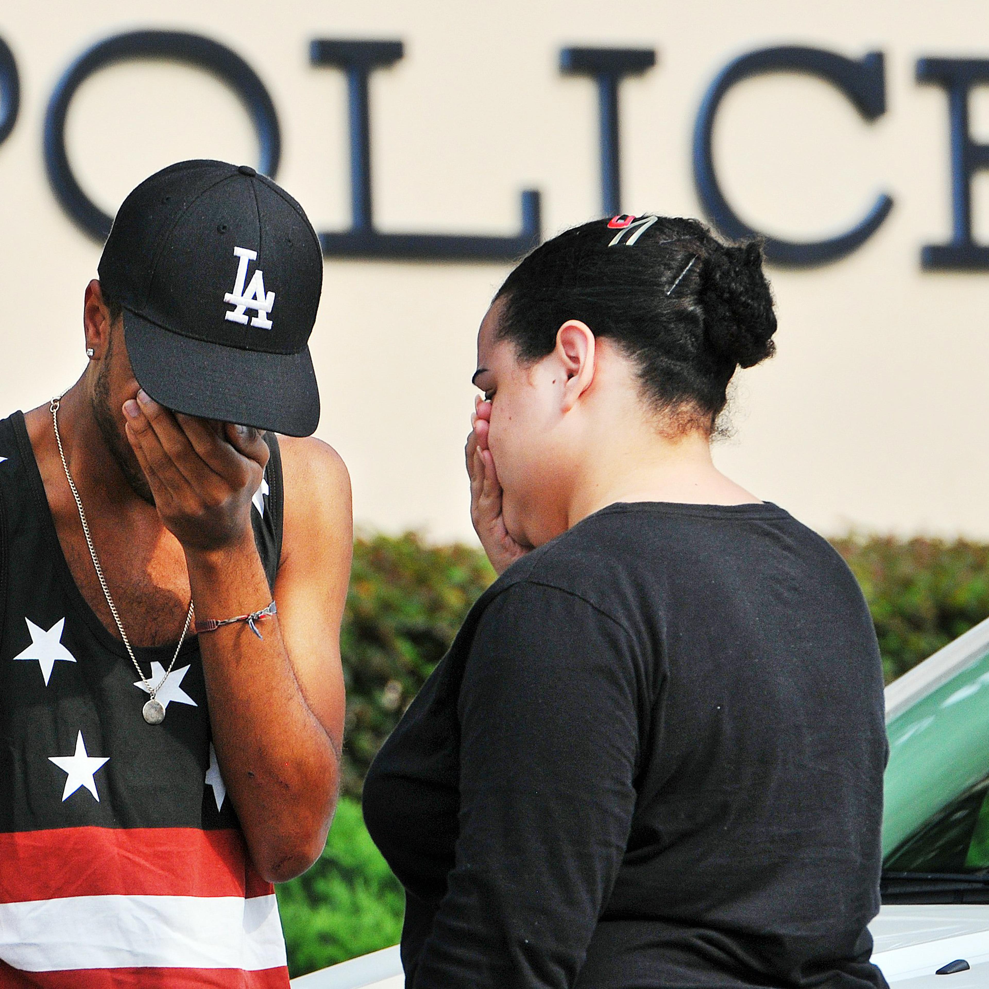 Victims and witnesses make their way out of the Orlando police headquarters building following an attack at the Pulse nightclub on June 12, 2016 in Orlando, Fla.