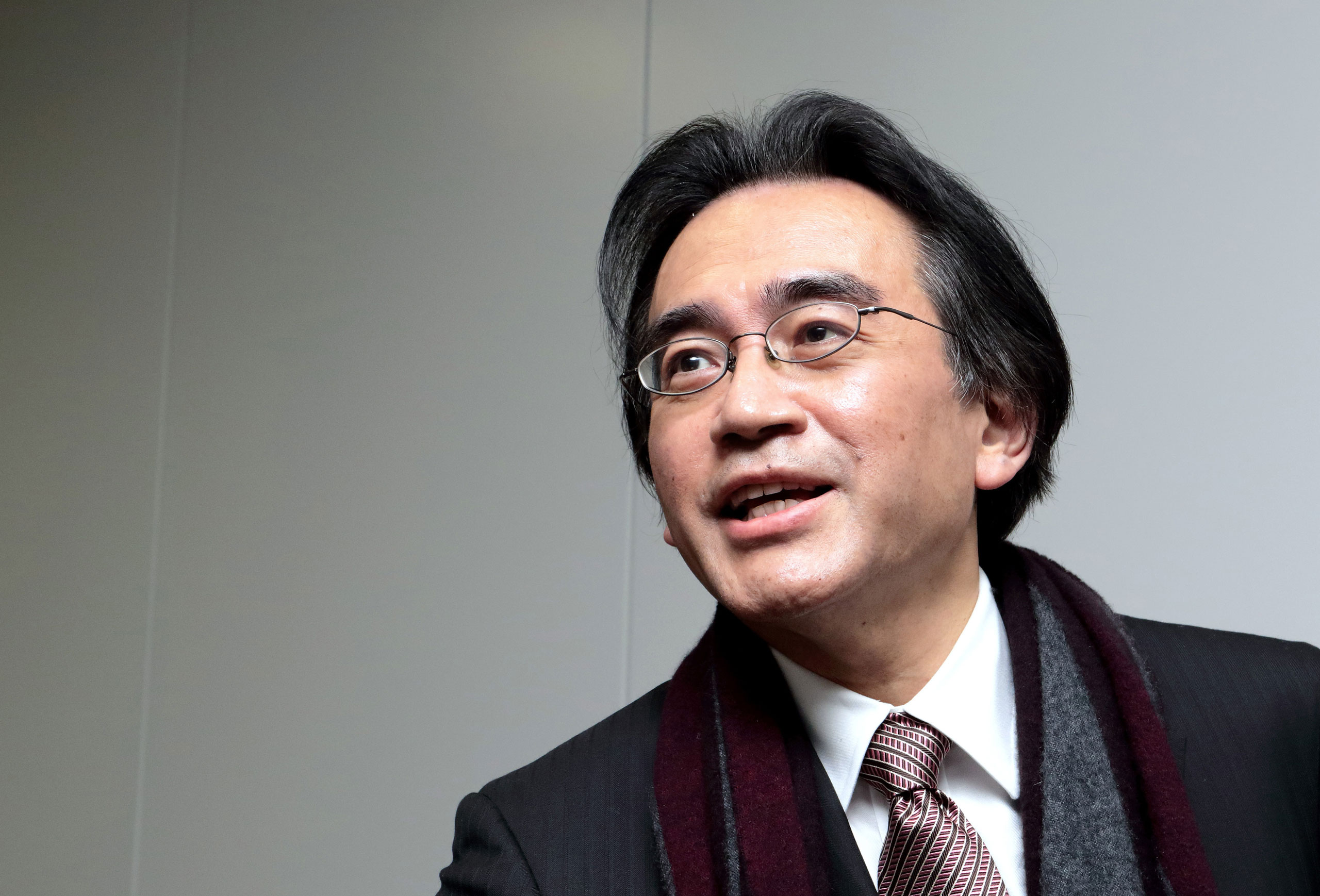 Satoru Iwata, president of Nintendo Co., speaks to reporters as he leaves a news conference in Osaka, Japan, on Wednesday, Jan. 28, 2015. Nintendo cuts to forecasts for profit and sales show even new titles with Mario can't make consumers choose its Wii 