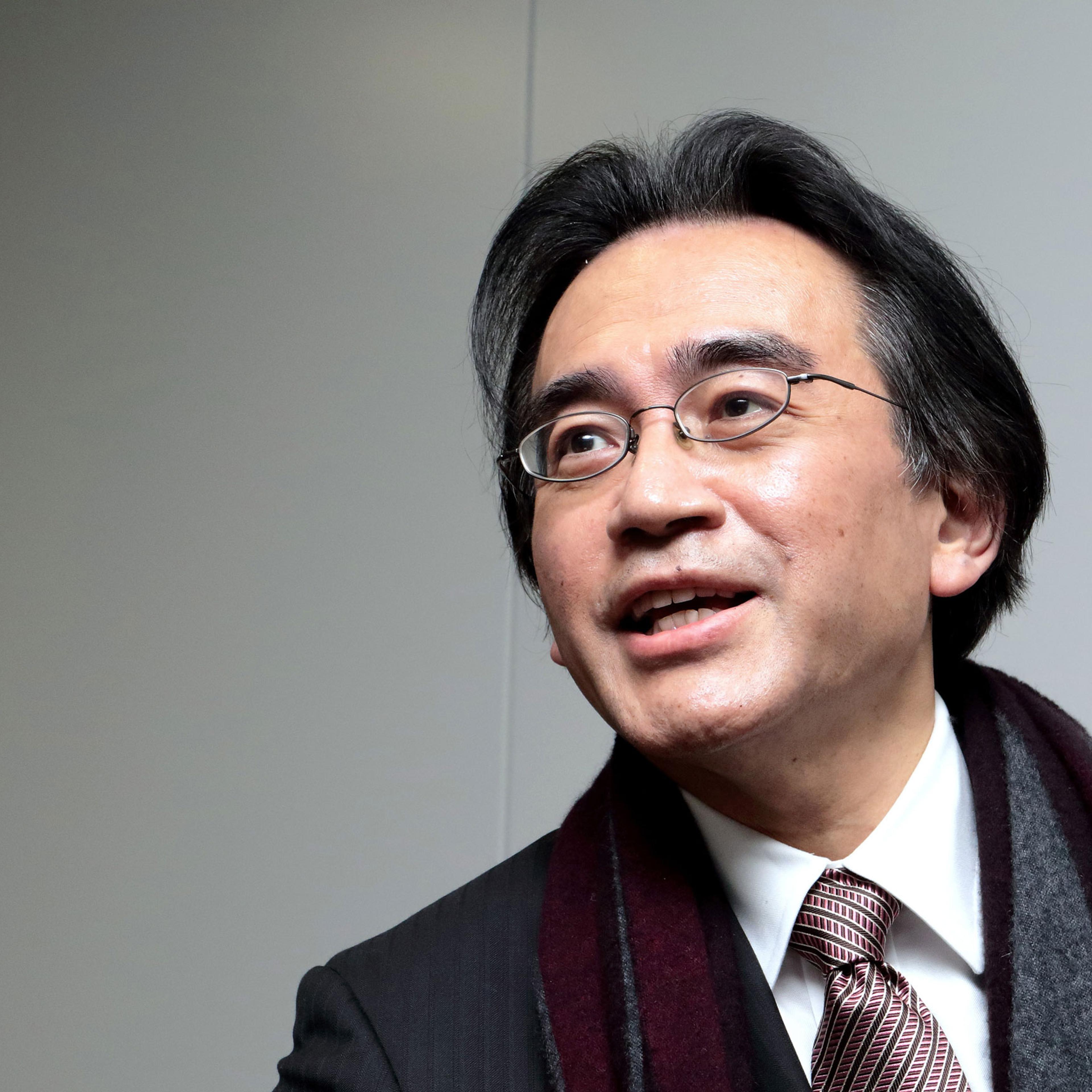 Satoru Iwata, president of Nintendo Co., speaks to reporters as he leaves a news conference in Osaka, Japan, on Wednesday, Jan. 28, 2015. Nintendo cuts to forecasts for profit and sales show even new titles with Mario can't make consumers choose its Wii