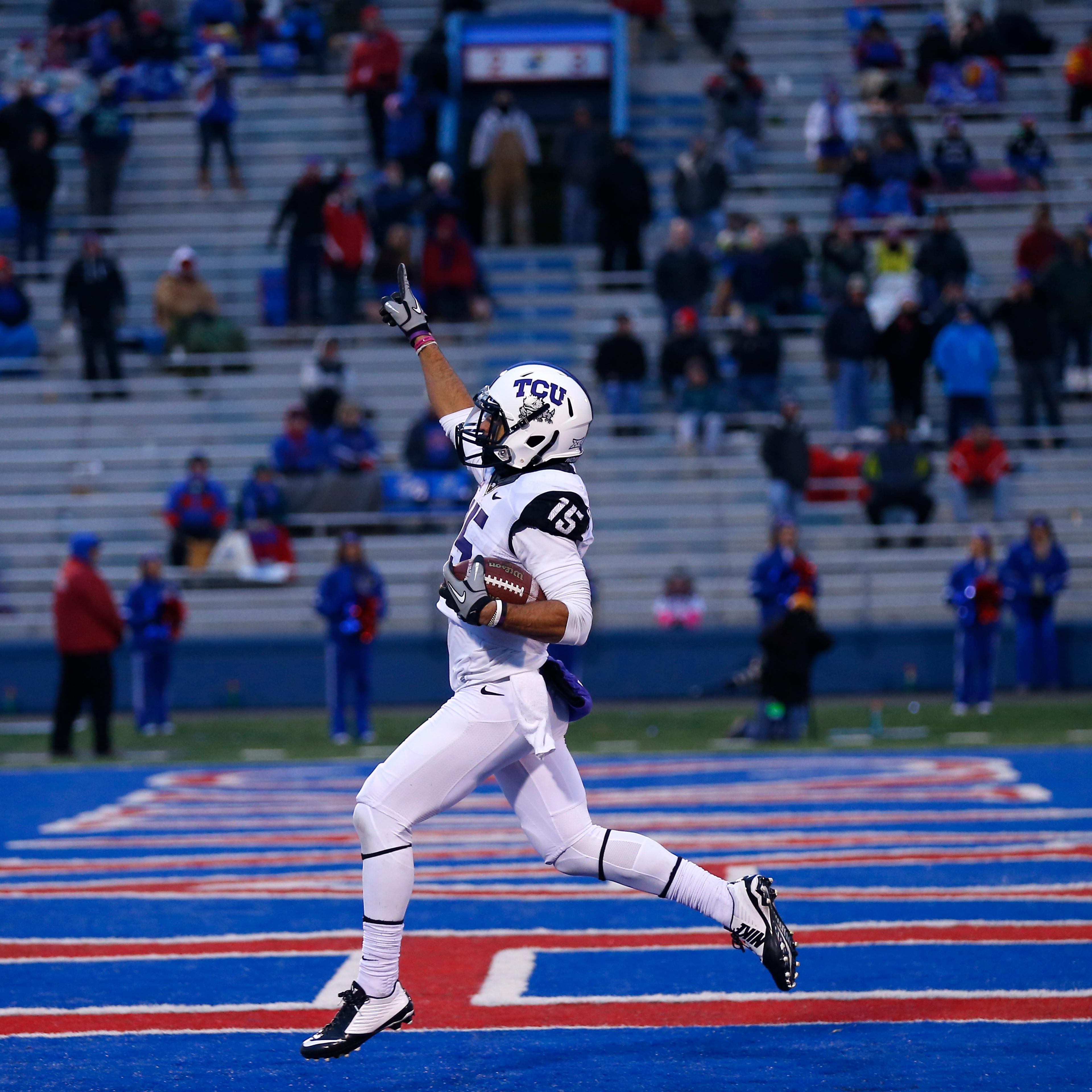 Cameron Echols-Luper of the TCU Horned Frogs celebrates his 69-yard punt return for a touchdown in the third quarter during a game against the Kansas Jayhawks at Memorial Stadium on Nov. 15, 2014 in Lawrence, Kansas.