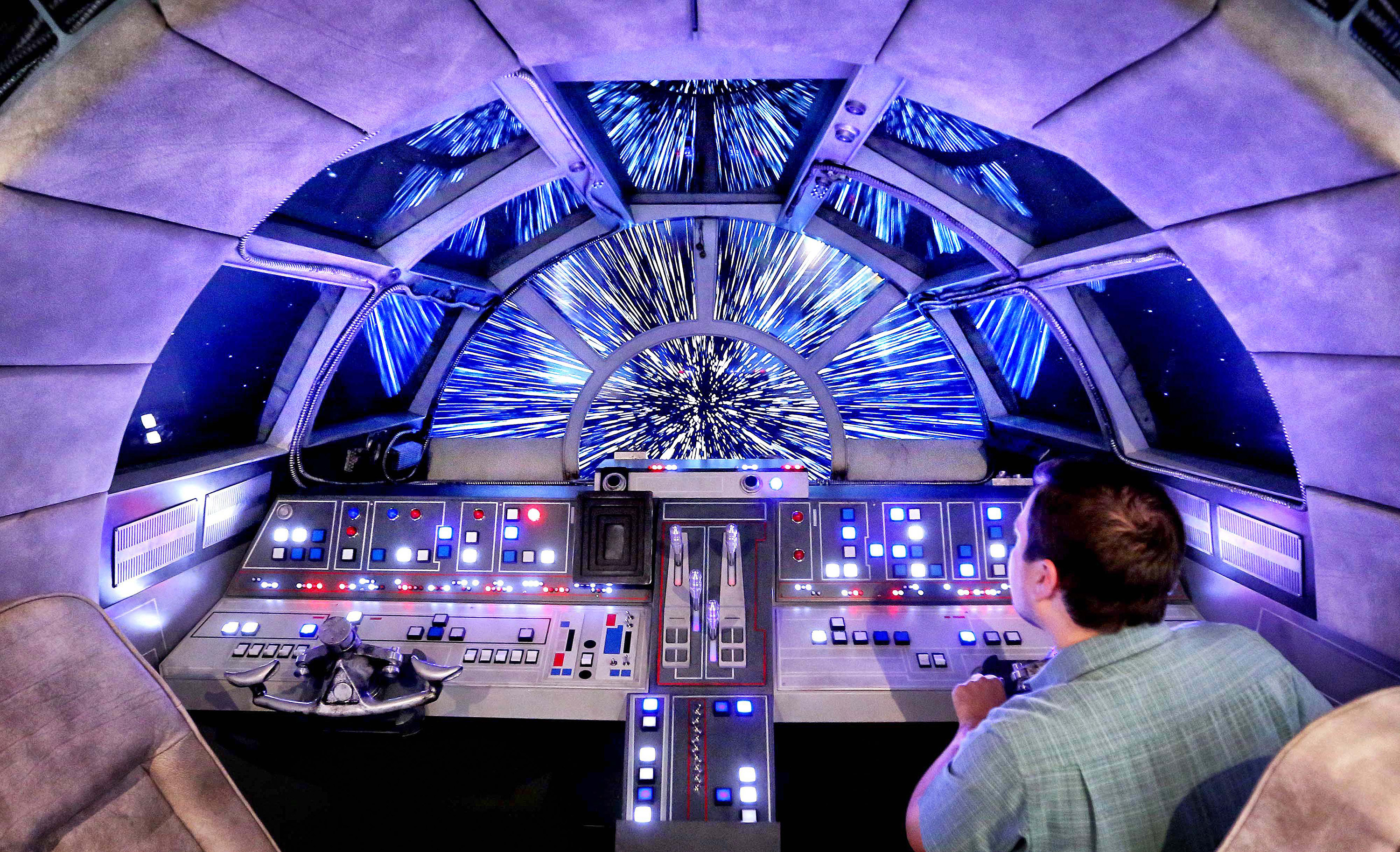 Danny Handke, a creative design executive with Walt Disney Imagineering, demonstrates the hyper reality of the cockpit in the new Star Wars Millennium Falcon play area onboard the Disney Dream, as Disney Cruise Lines unveils the enhancements to the ship 