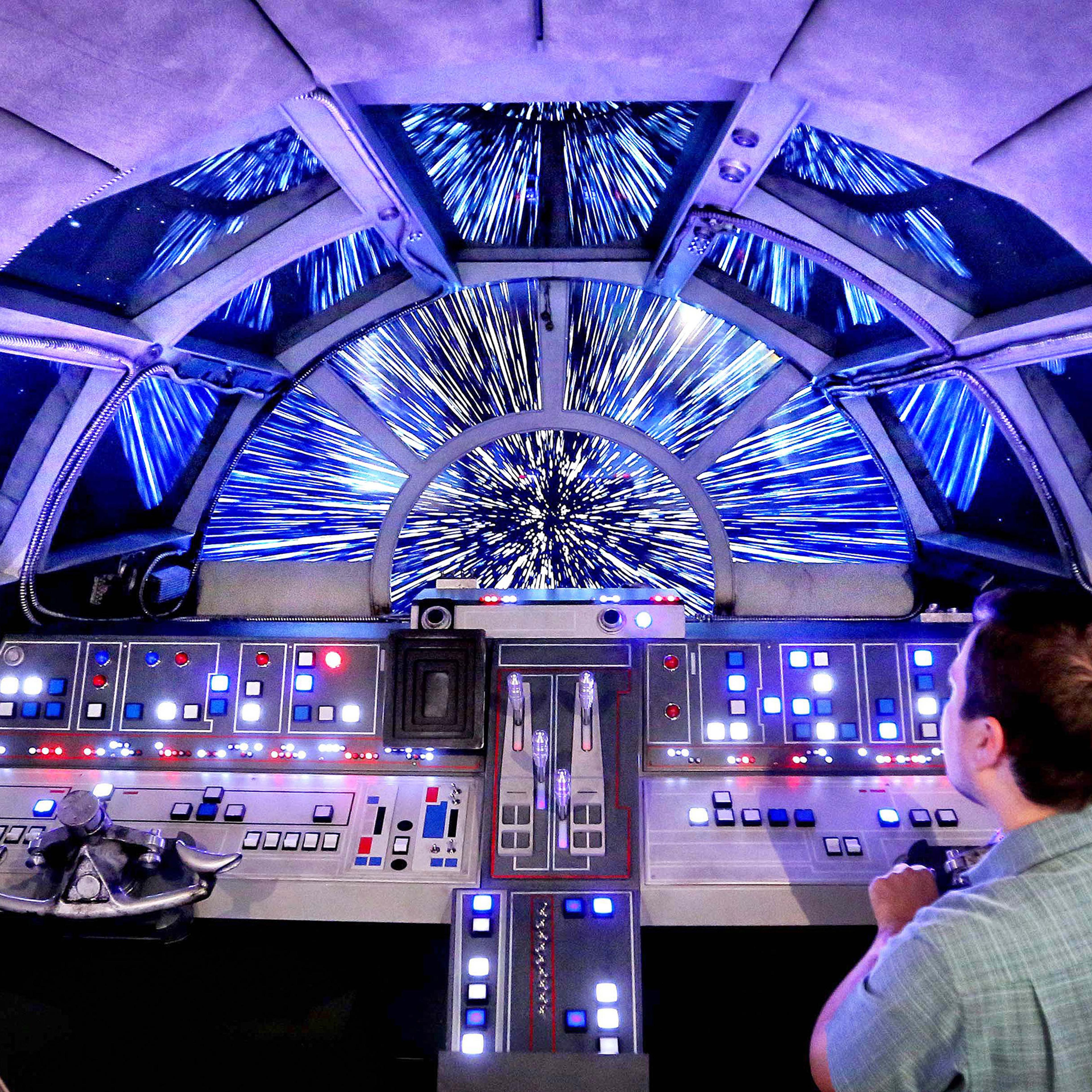 Danny Handke, a creative design executive with Walt Disney Imagineering, demonstrates the hyper reality of the cockpit in the new Star Wars Millennium Falcon play area onboard the Disney Dream, as Disney Cruise Lines unveils the enhancements to the ship