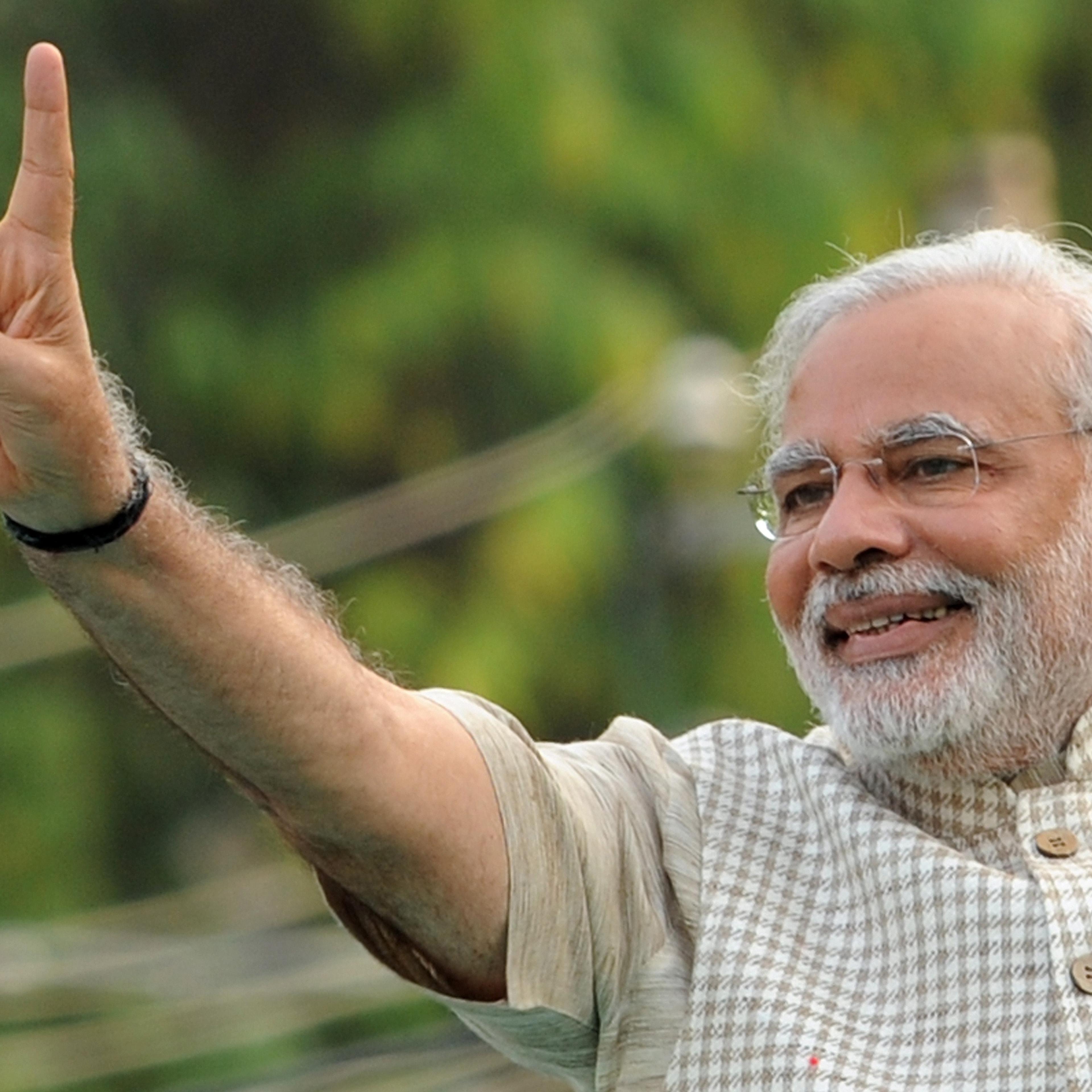 Chief Minister of western Gujarat state and main opposition Bharatiya Janata Party (BJP) prime ministerial candidate Narendra Modi flashes the victory sign as he arrives at a public rally after his victory in Vadodara on May 16, 2014.