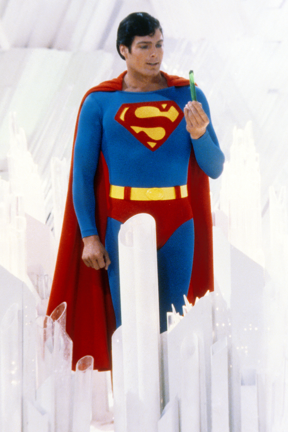 Superman, played by American actor Christopher Reeve (1952 - 2004), holds a green crystal at the Fortress of Solitude, in a promotional still from 'Superman', directed by Richard Donner, 1978.