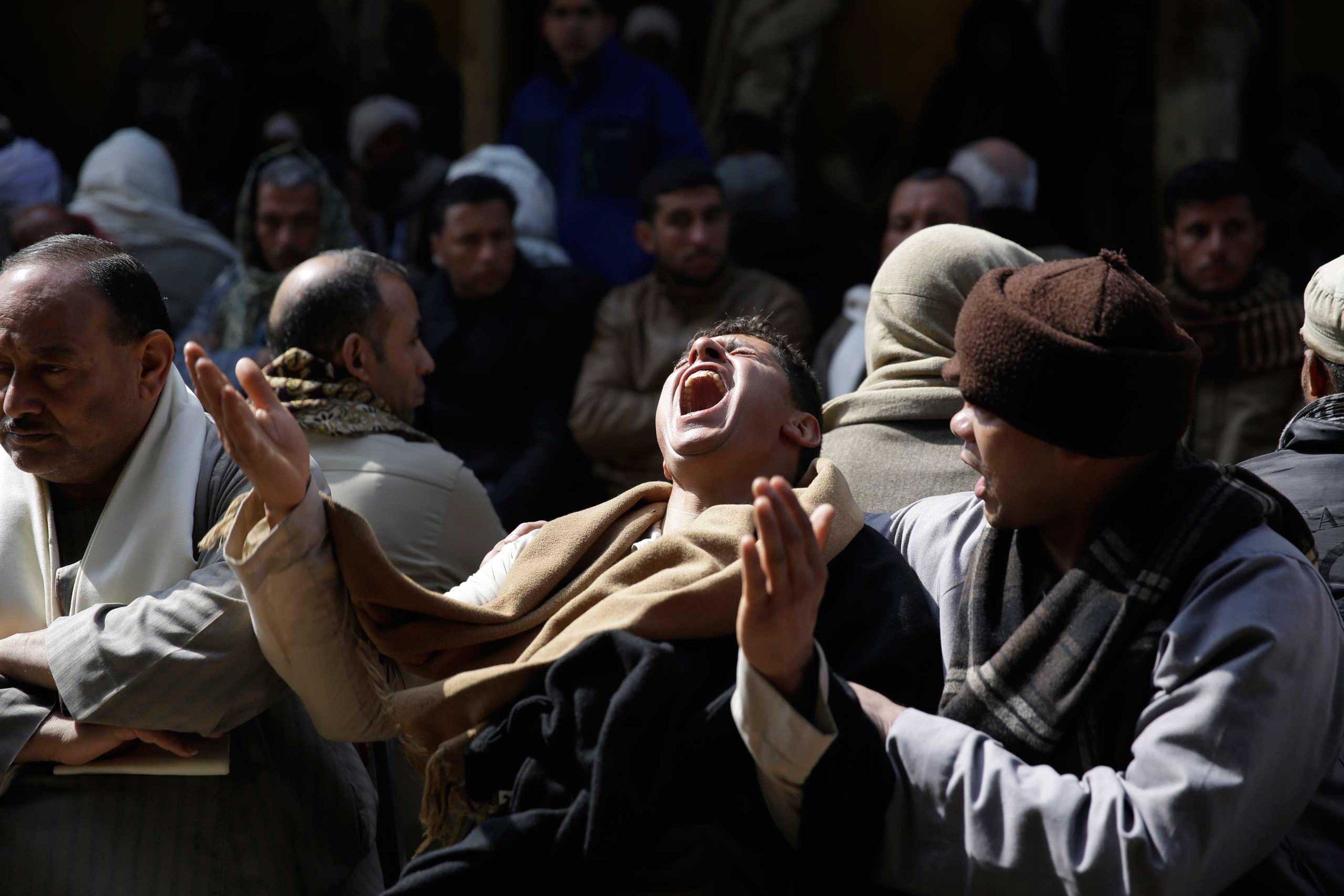 Egyptian Coptic men mourn for 21 Coptic Egyptian men seized by Islamic State militants in the central city of Sirte, Libya, more than a month ago at the Virgin Mary Church in the village of el-Aour, near Minya, 135 miles south of Cairo, Feb. 16, 2015.