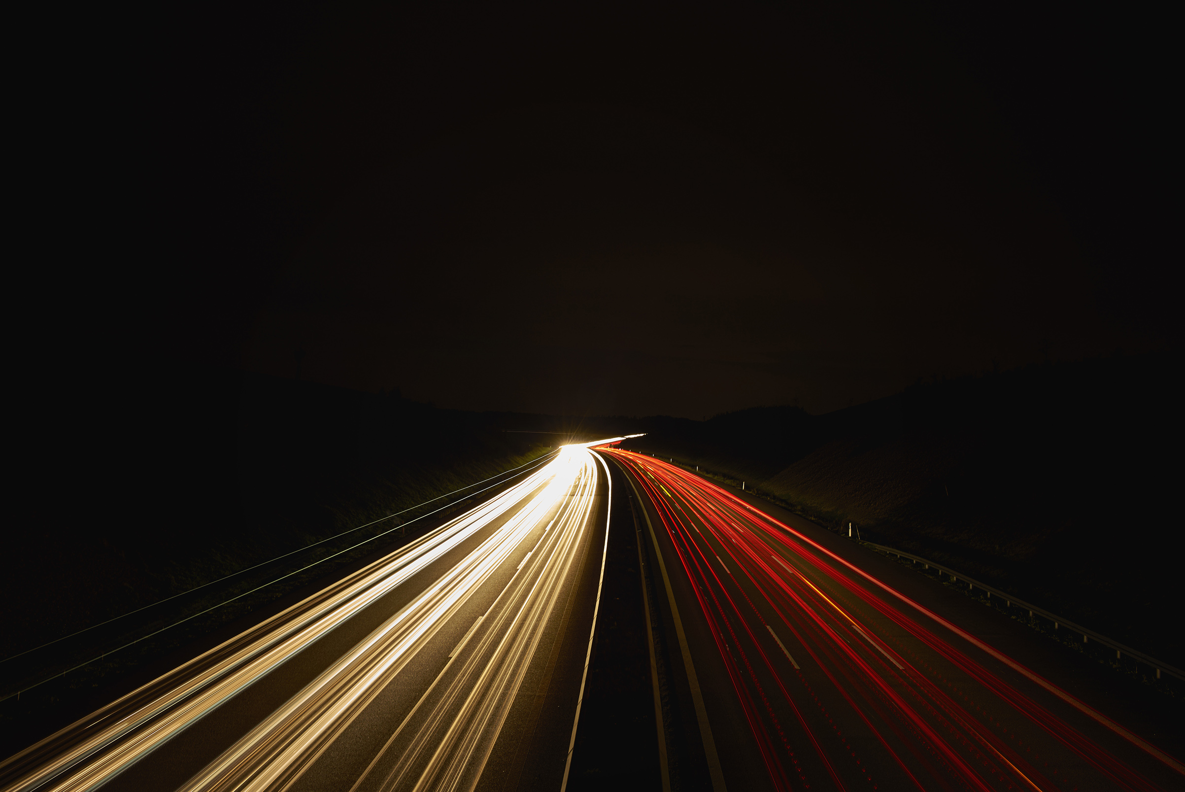 Germany, red and white lighttrails on freeway by night, long exposure