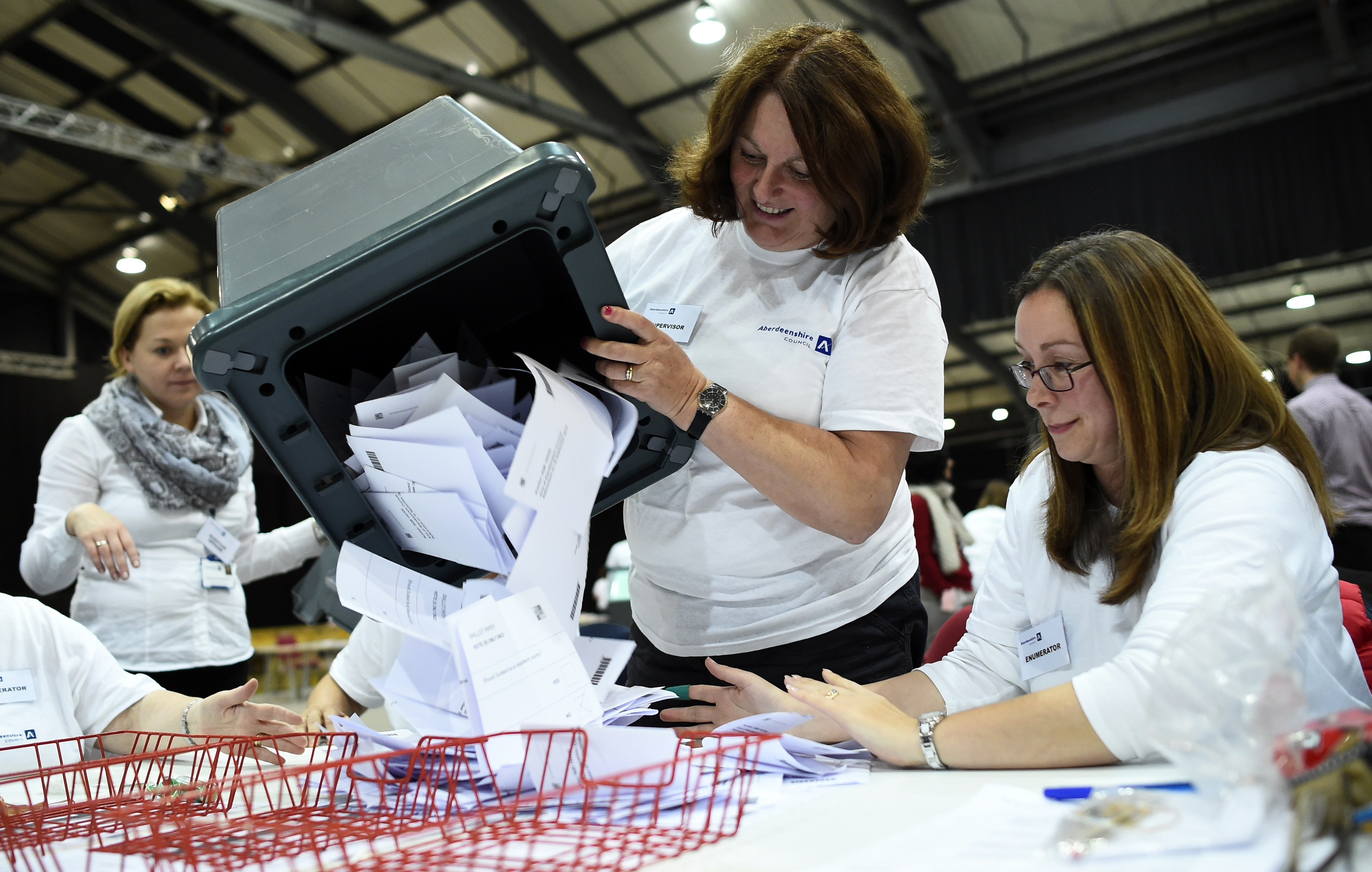 A ballot box is emptied as workers prepare to count ballots at a counting centre in Aberdeen, Scotland