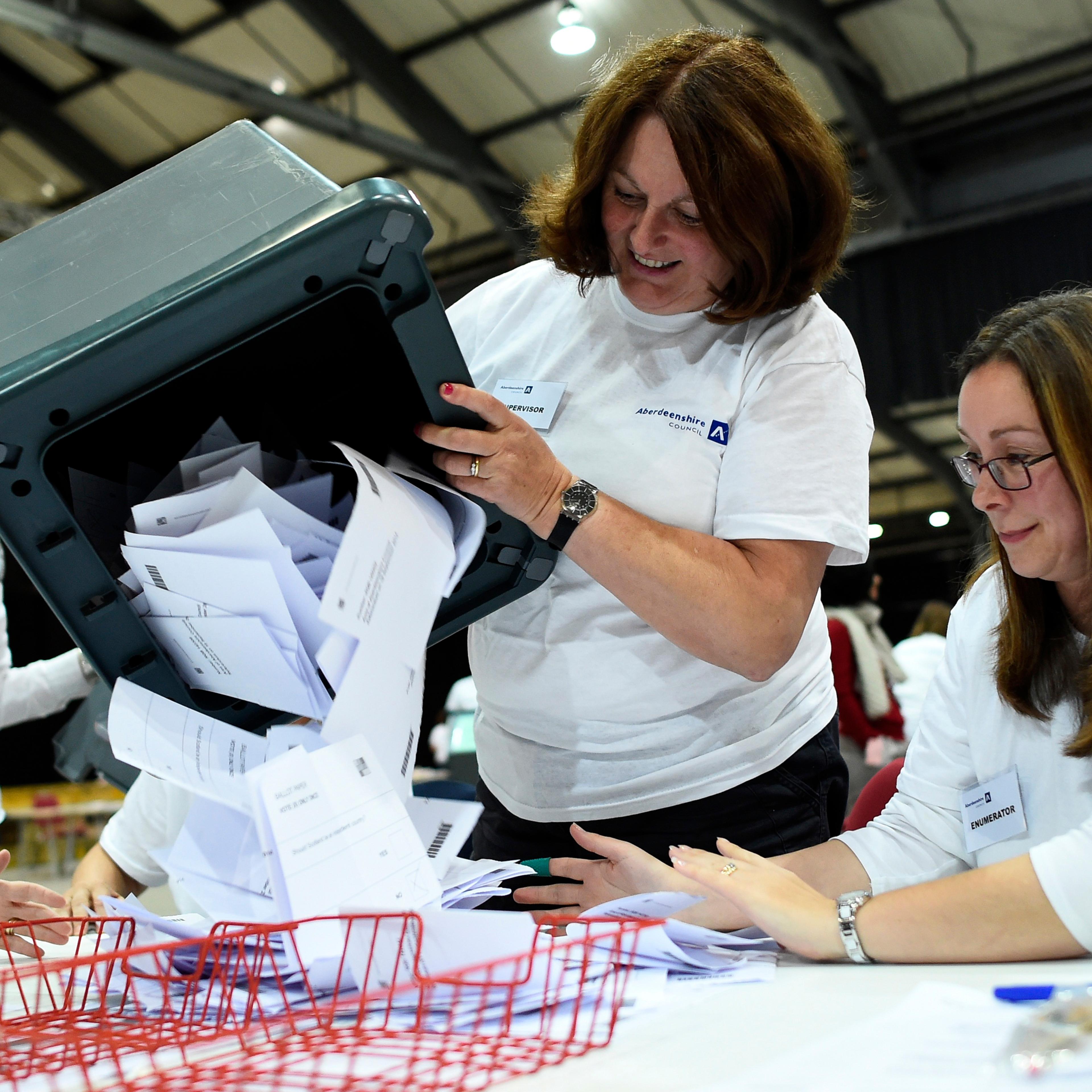A ballot box is emptied as workers prepare to count ballots at a counting centre in Aberdeen, Scotland