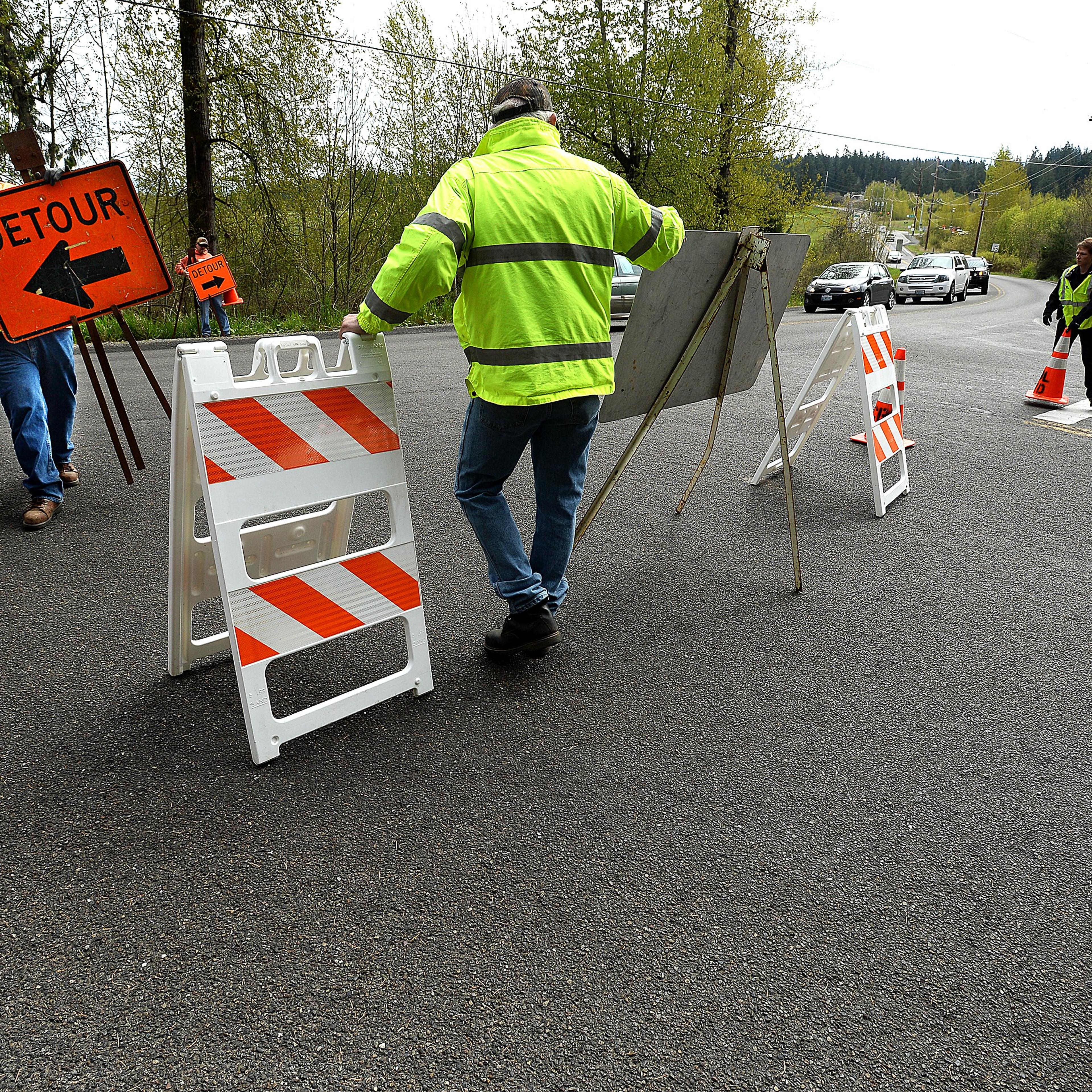 Workers with the Bonney Lake Public Works Department set up signs on April 13, 2015 in Bonney Lake, Wash.