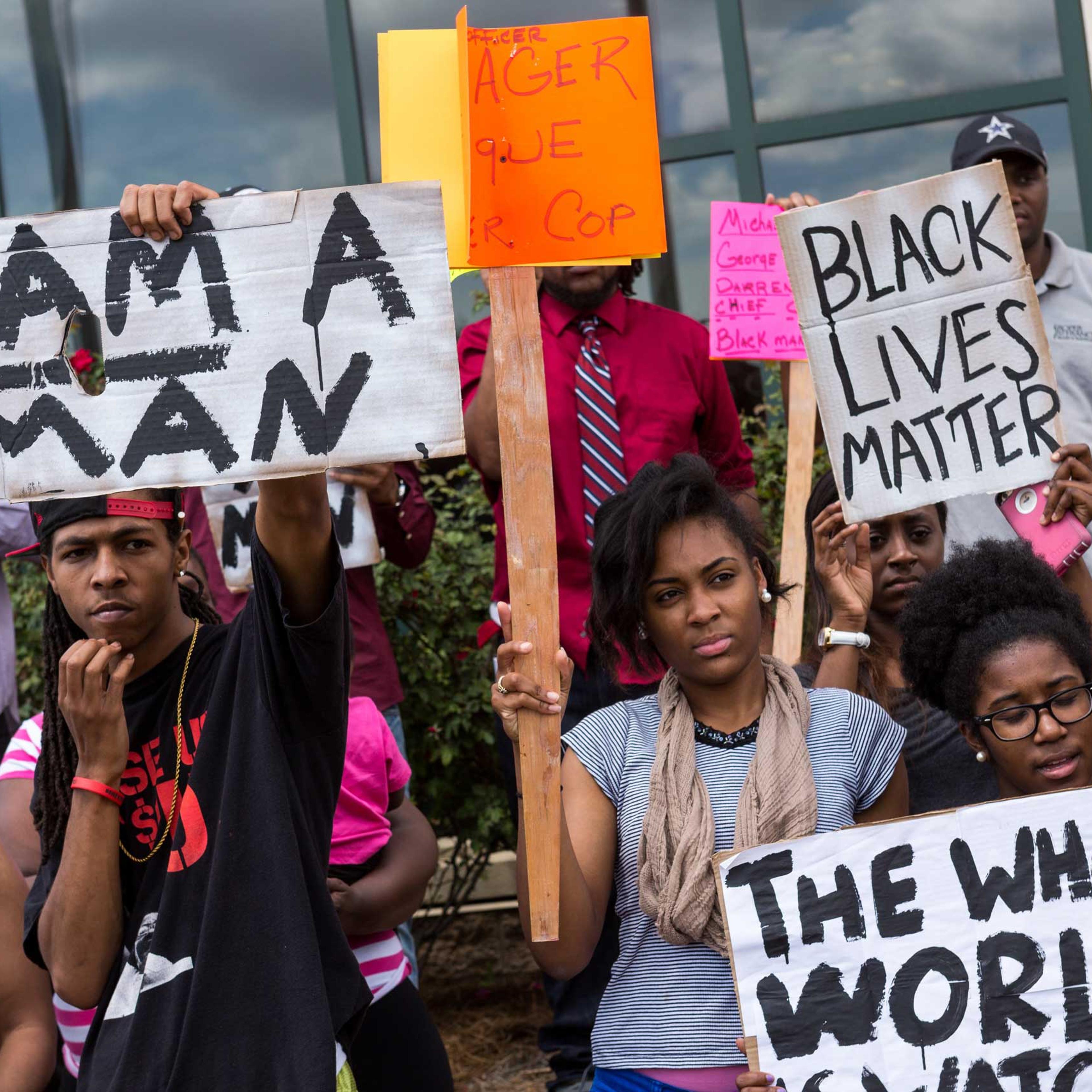 People participate in a rally to protest the death of Walter Scott, who was killed by police in a shooting, outside City Hall in North Charleston, S.C., on April 8, 2015.