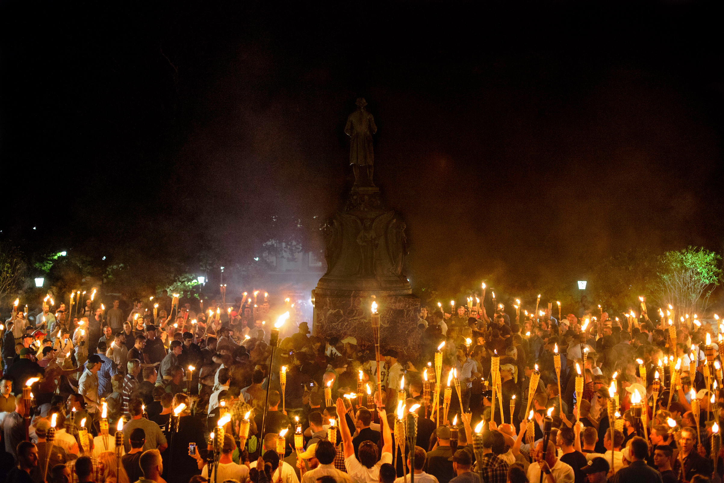 Neo-Nazis and white supremacists encircle counter-protestors at the base of a statue of Thomas Jefferson after marching through the University of Virginia campus with torches in Charlottesville, Va., on Aug. 11, 2017.