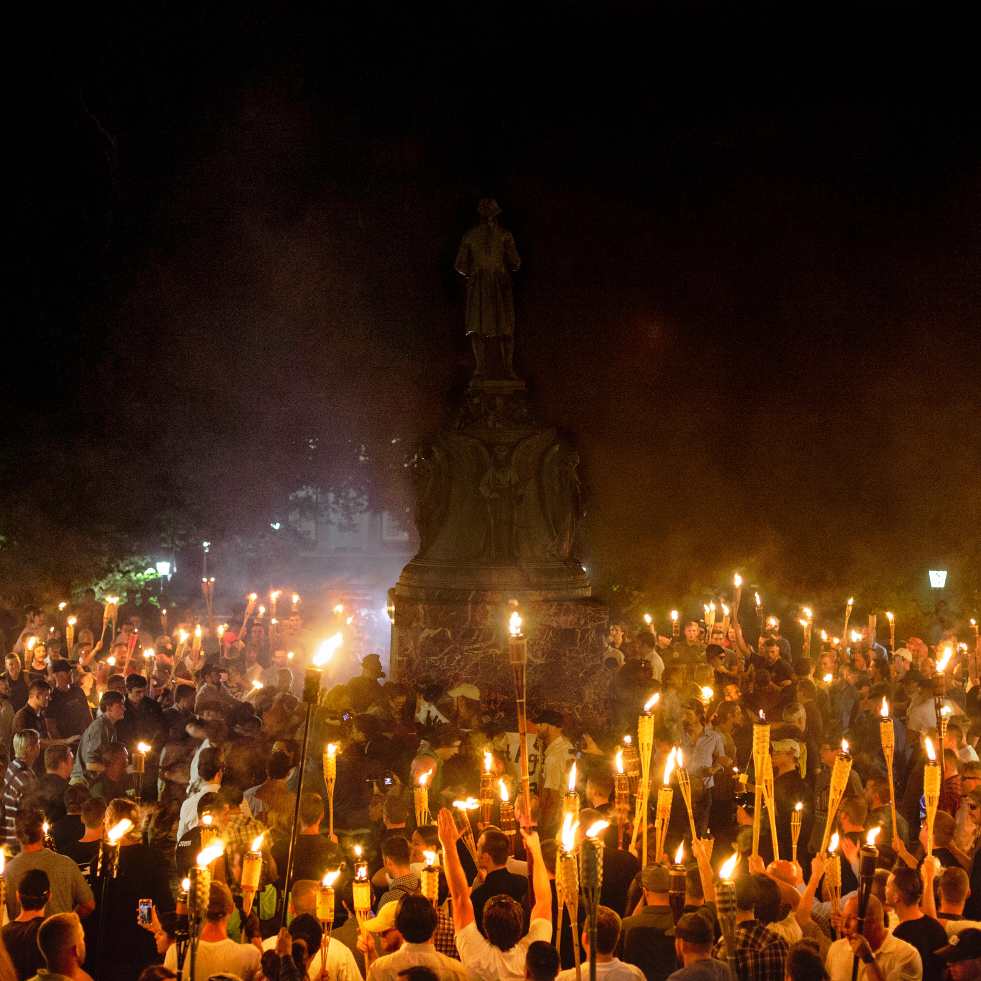 Neo-Nazis and white supremacists encircle counter-protestors at the base of a statue of Thomas Jefferson after marching through the University of Virginia campus with torches in Charlottesville, Va., on Aug. 11, 2017.