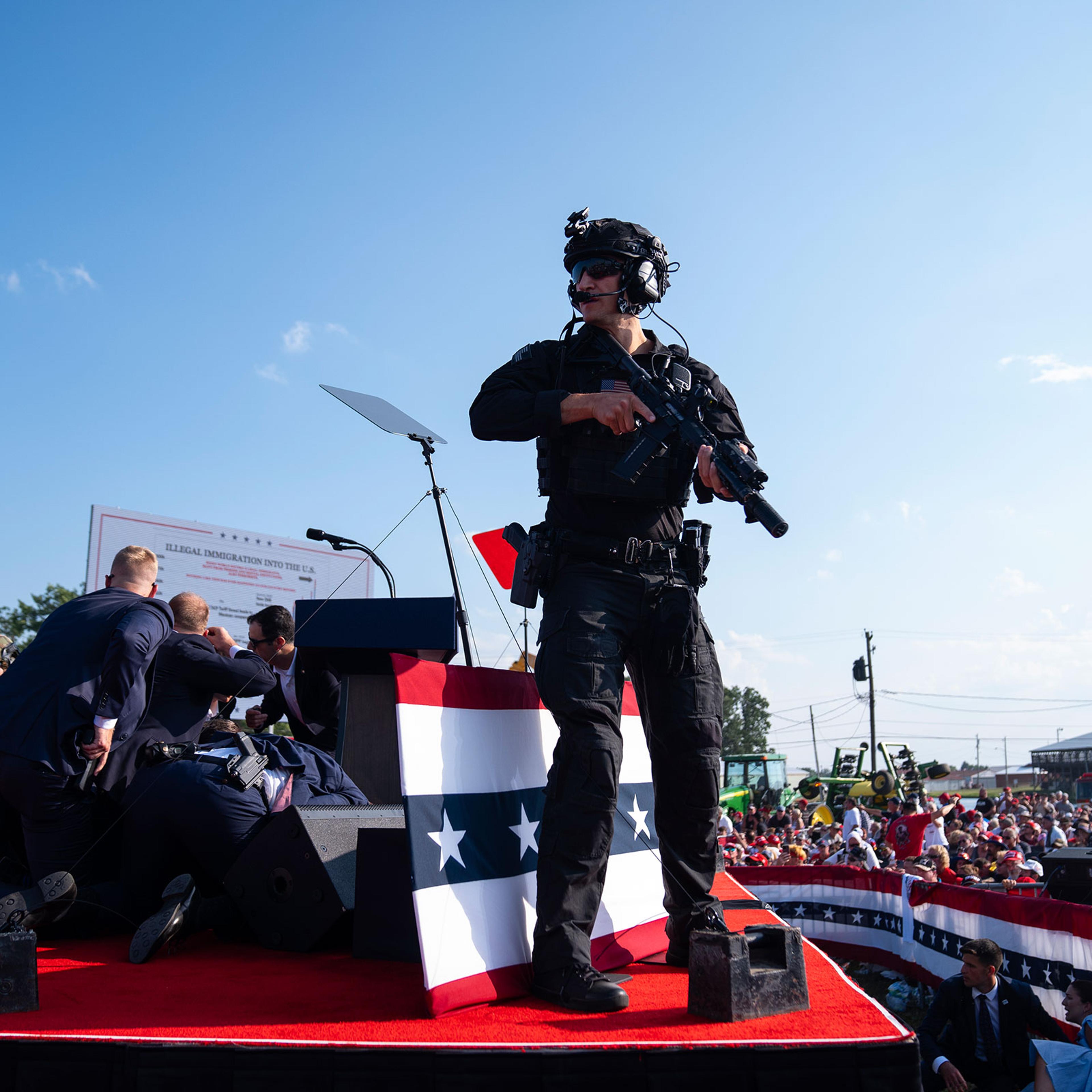 Republican presidential candidate former President Donald Trump is surrounded by U.S. Secret Service agents at a campaign rally in Butler, Pa., on July 13, 2024.